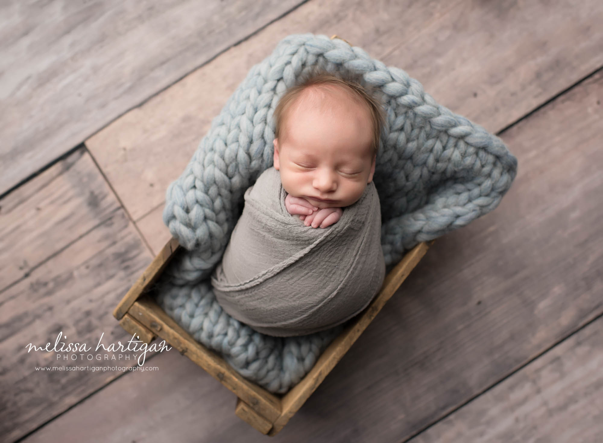 Newborn Photographer Connecticut newborn pose baby sleeping in wooden crate in gray wrap