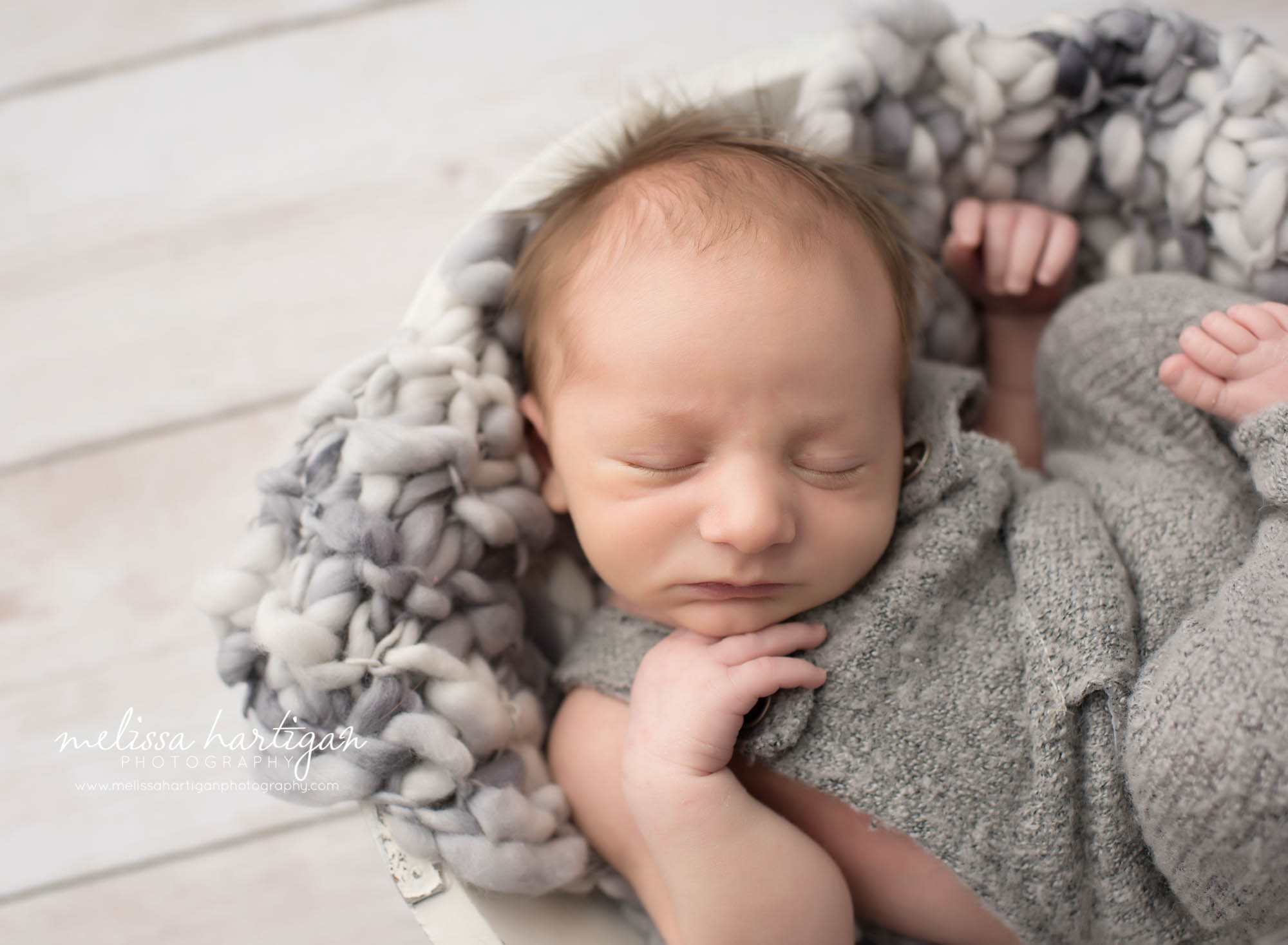 Newborn Photographer Connecticut newborn pose baby sleeping wearing gray knit overalls