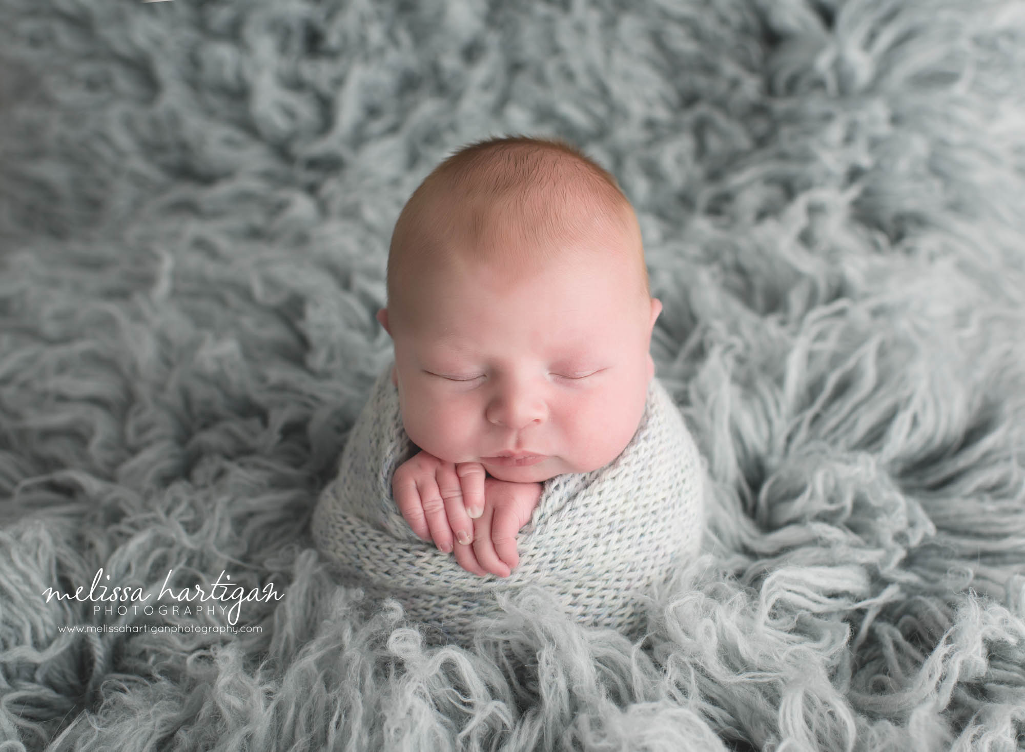 Newborn Photographer CT newborn pose baby wrapped in blue