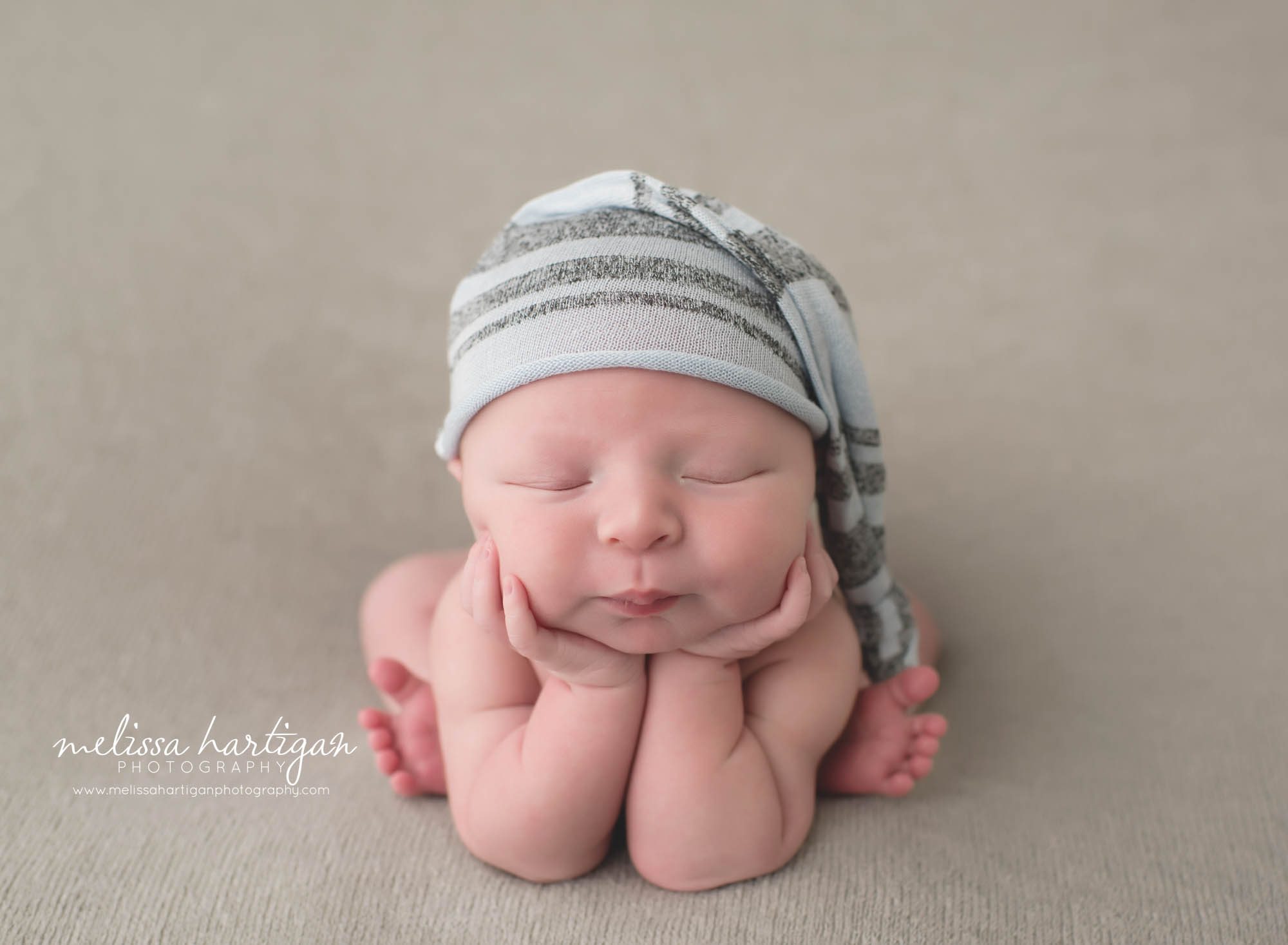 Newborn Photographer CT newborn pose froggy with blue striped hat
