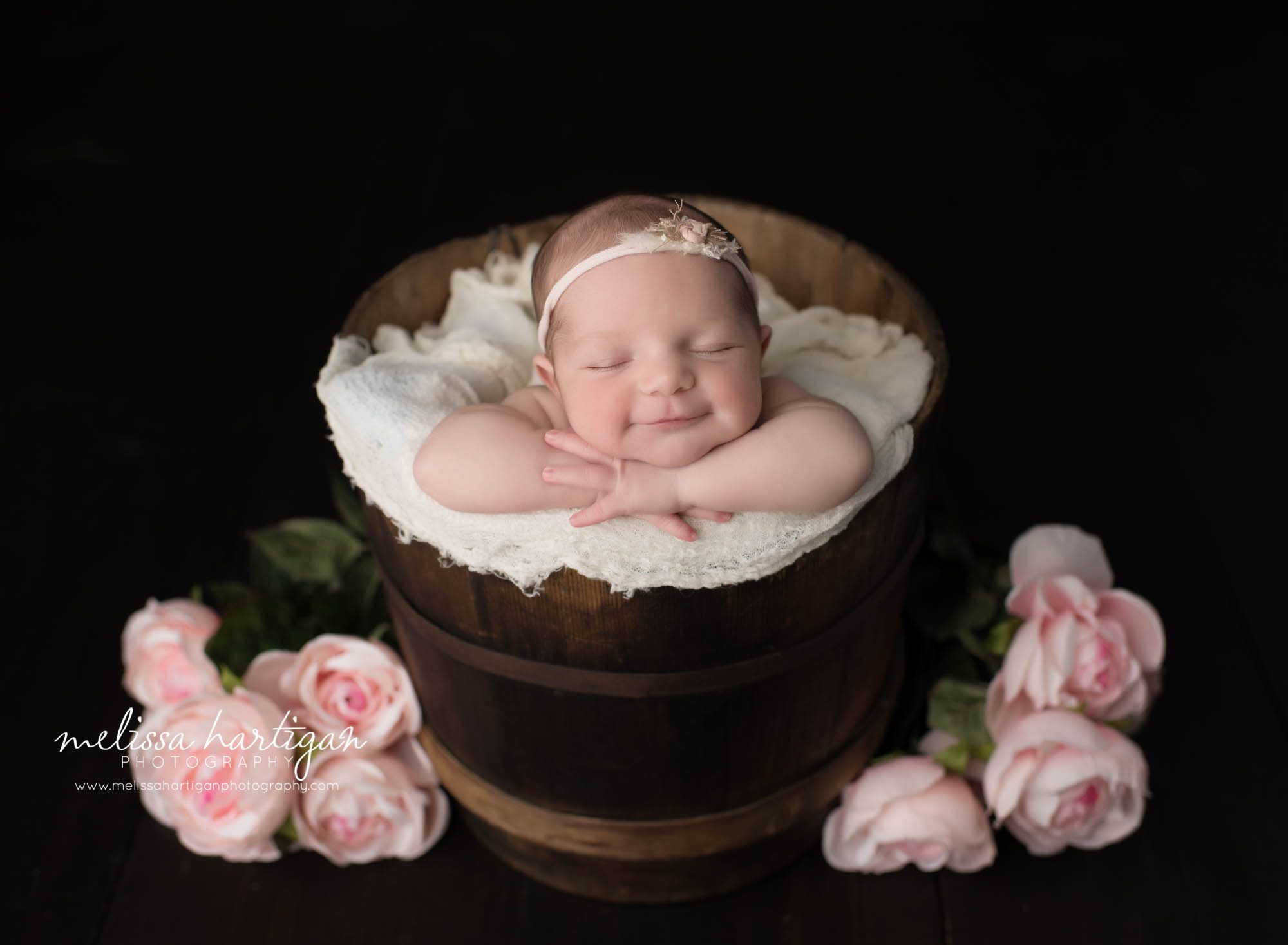 Connecticut Newborn Photographer baby in bucket smiling