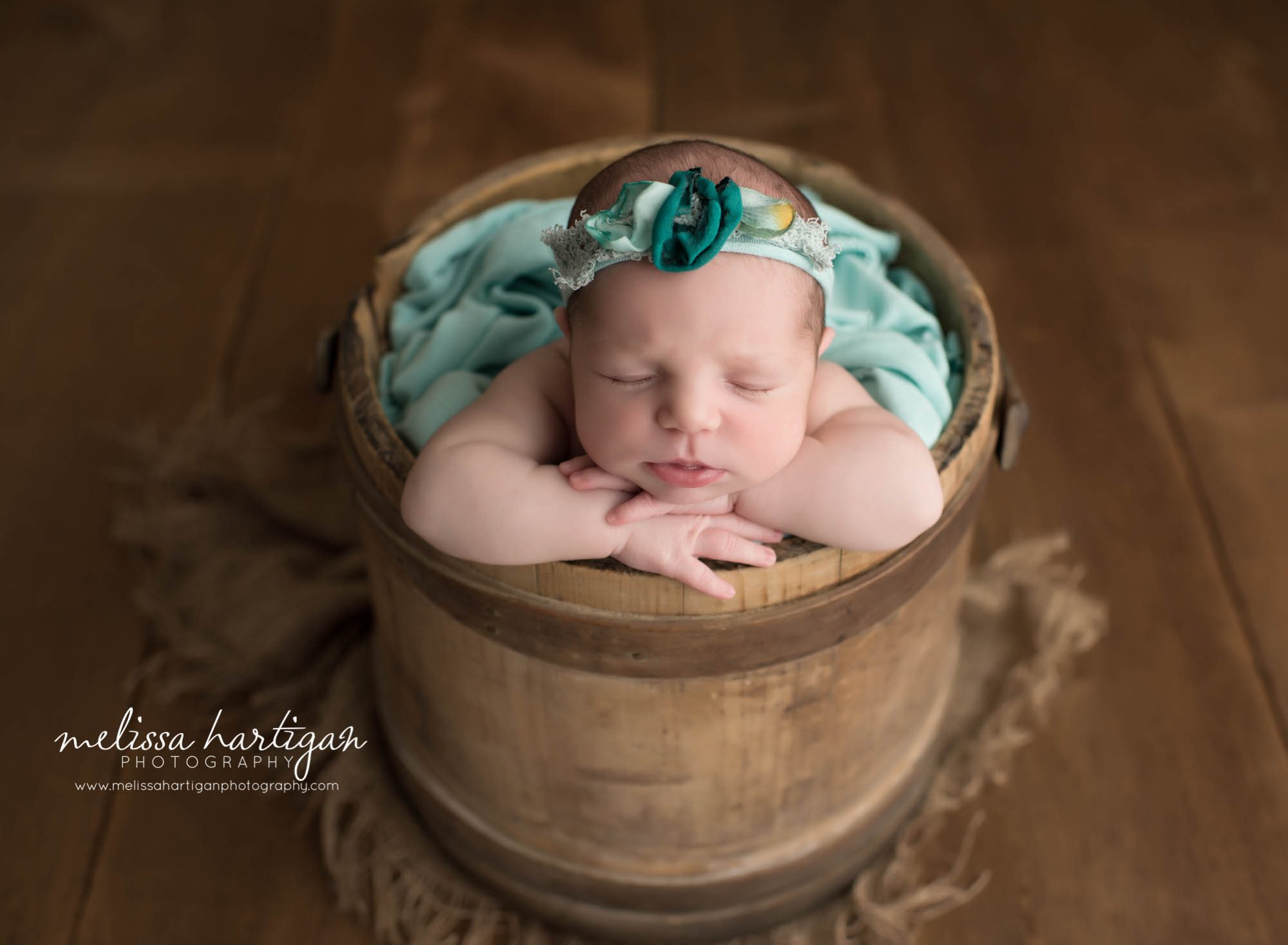 Connecticut Newborn Photographer baby in barrel with floral headband