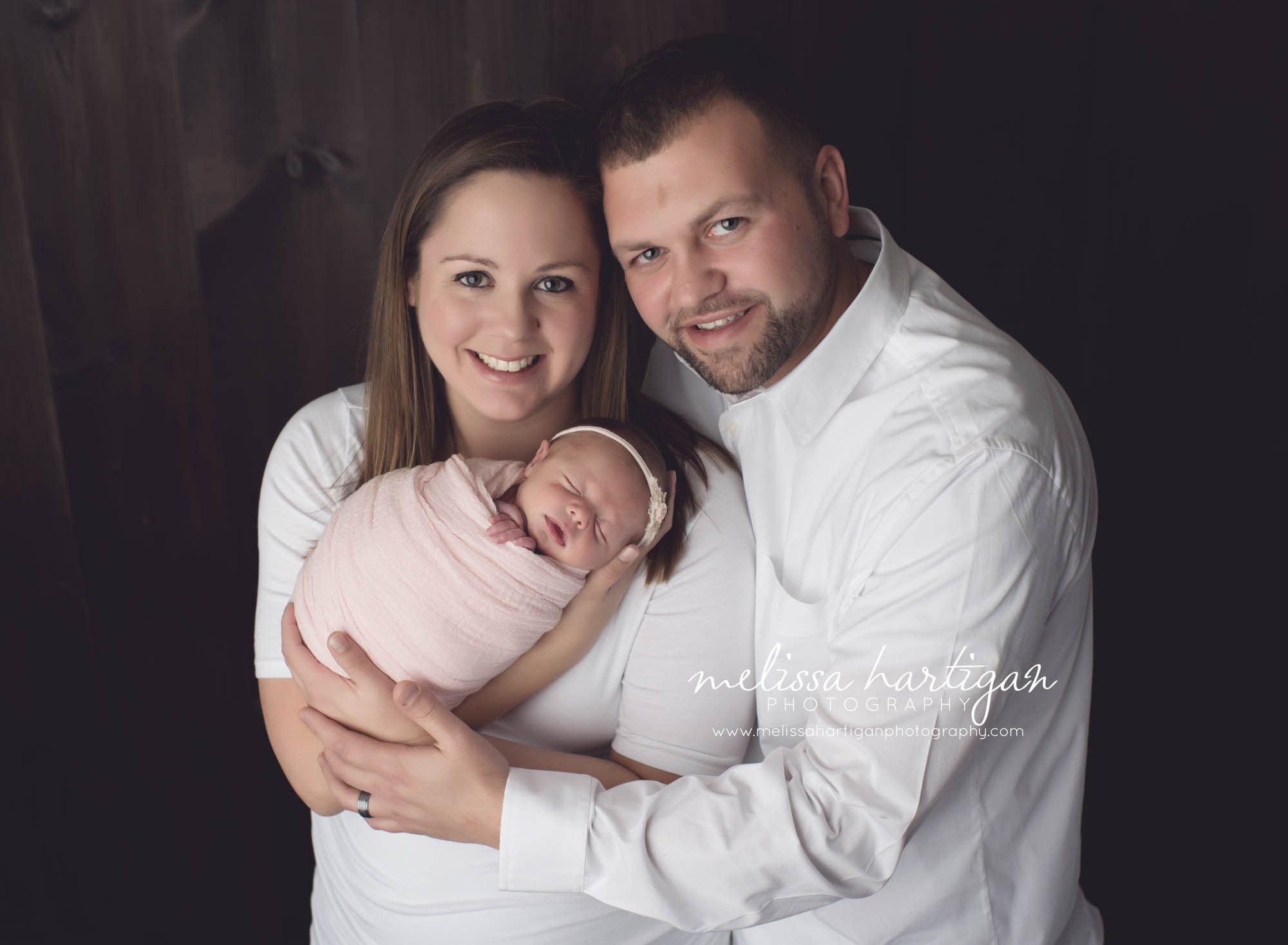 CT Baby Photographer family pose with newborn wrapped in pink