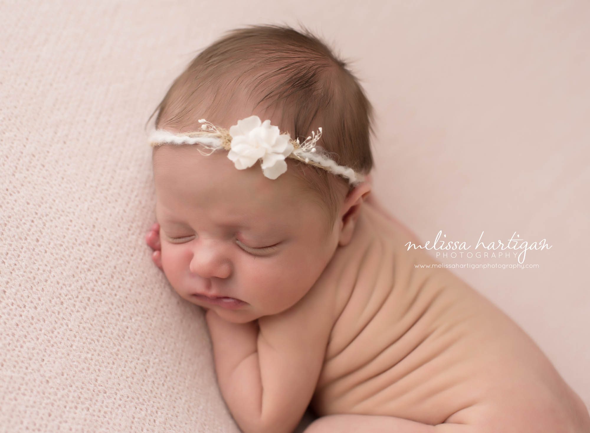 CT Baby Photographer newborn sleeping with white headband on pink blanket