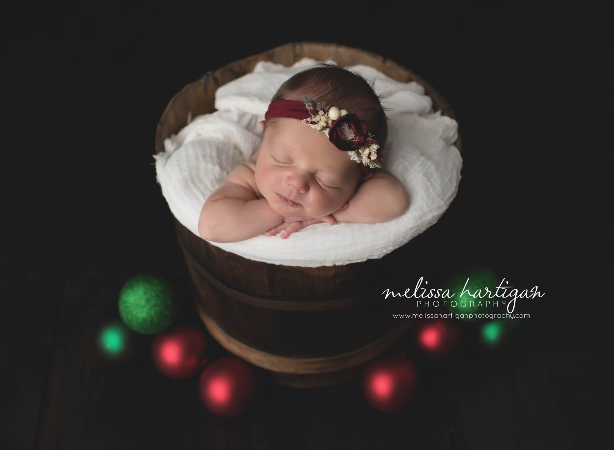 CT Baby Photographer holiday set-up sleeping in wooden bucket with Christmas balls
