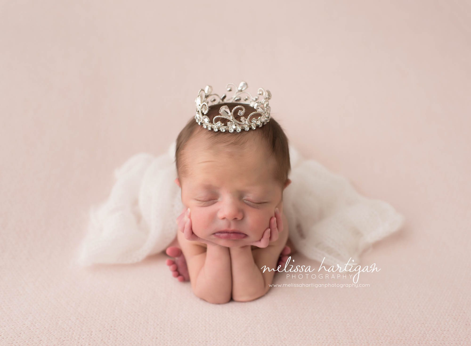 CT Baby Photographer froggy pose wearing a tiara on pink blanket