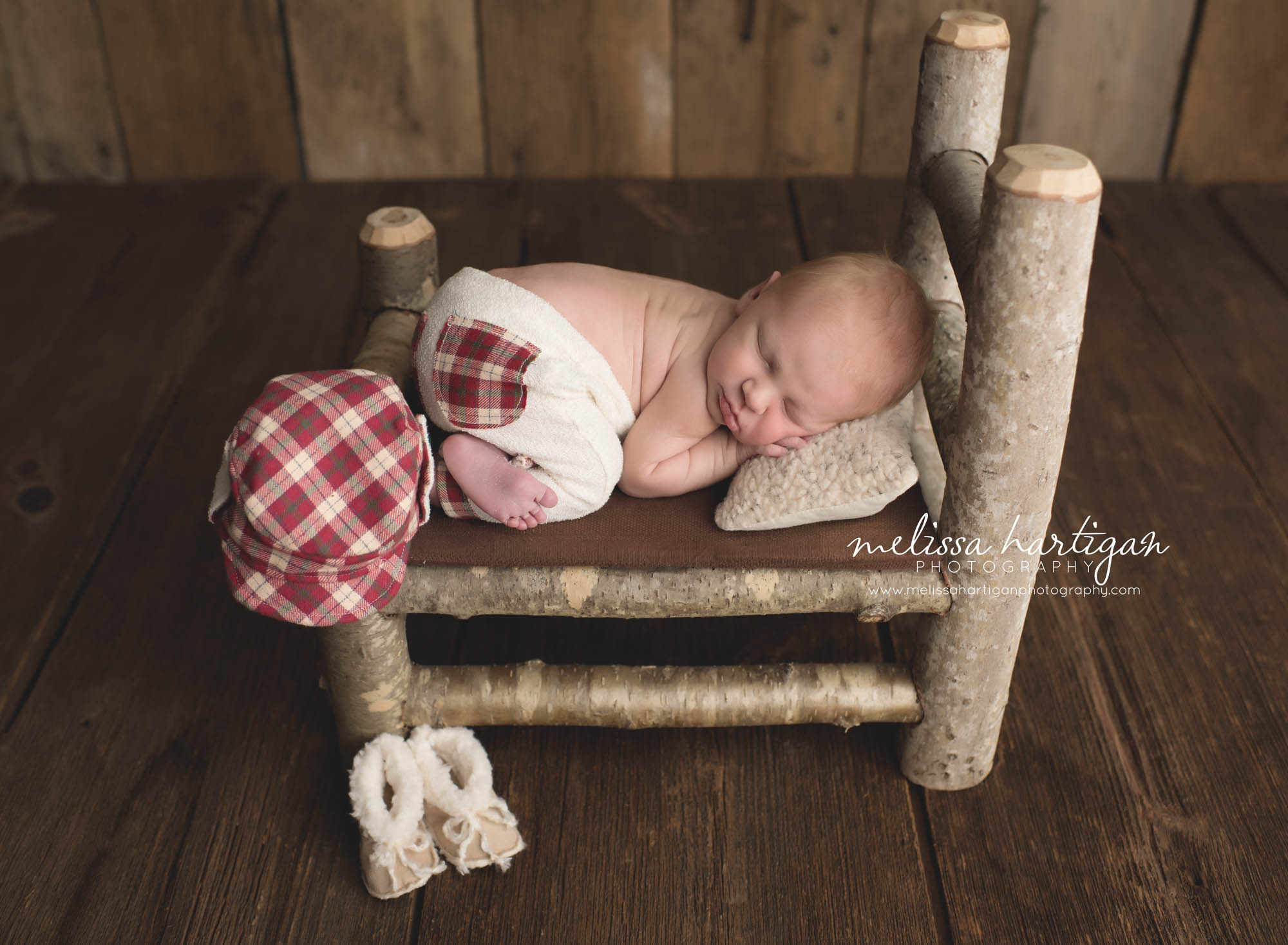 CT Baby Photography newborn boy sleeping in rustic bed with plaid pants and hat