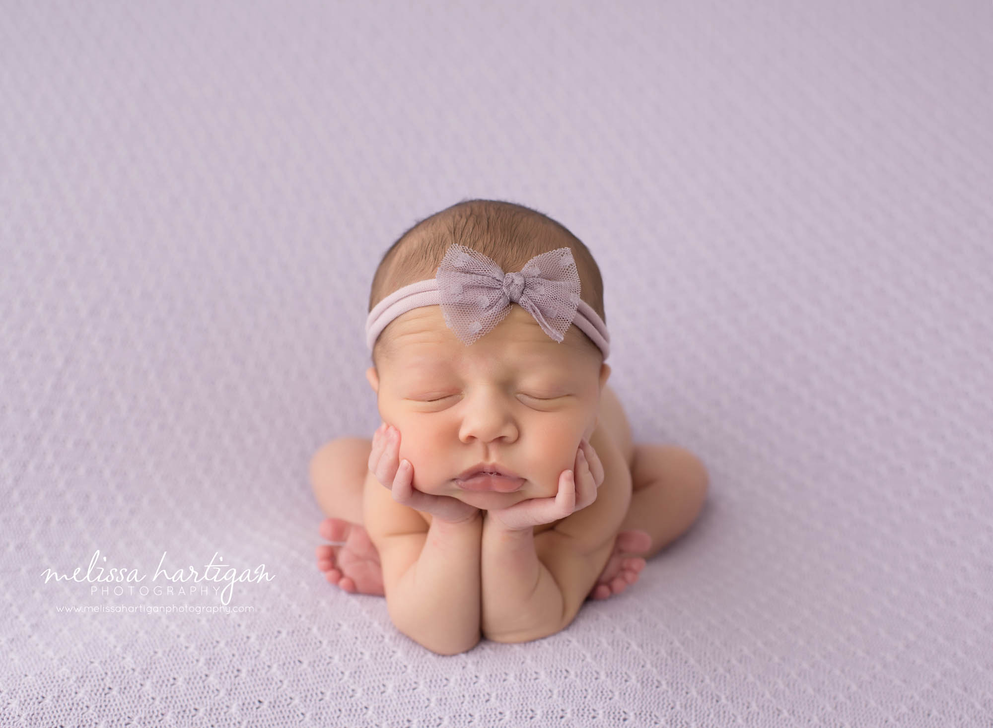 Baby girl in froggy pose on lavender blanket newborn photography in CT photography studio Melissa Hartigan
