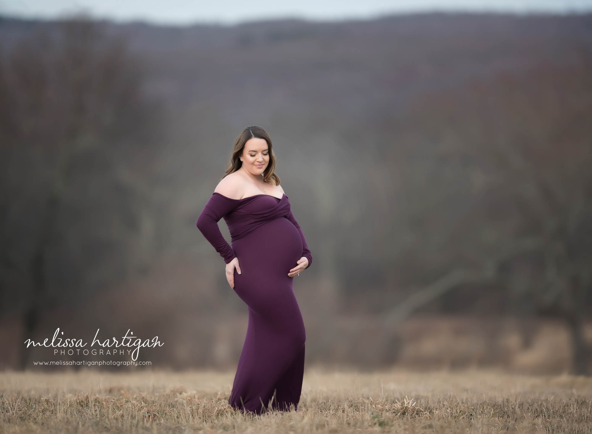 expectant mom standing pregnancy pose flattering baby bump winter maternity photos with no snow