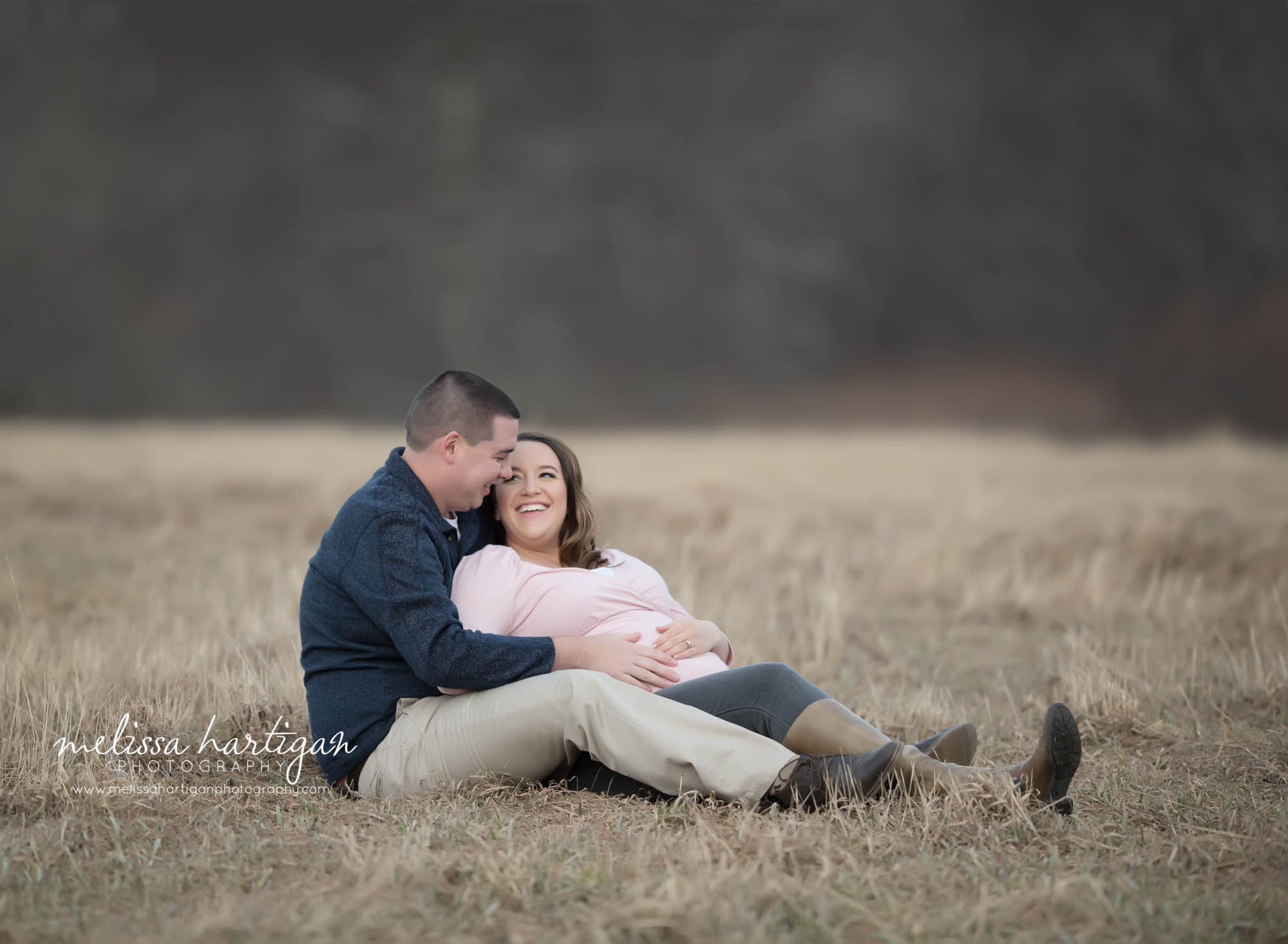 Couples sitting down relaxed pose expectant parents holding belly waiting for baby girl CT maternity photography Maternity Baby Photographers CT