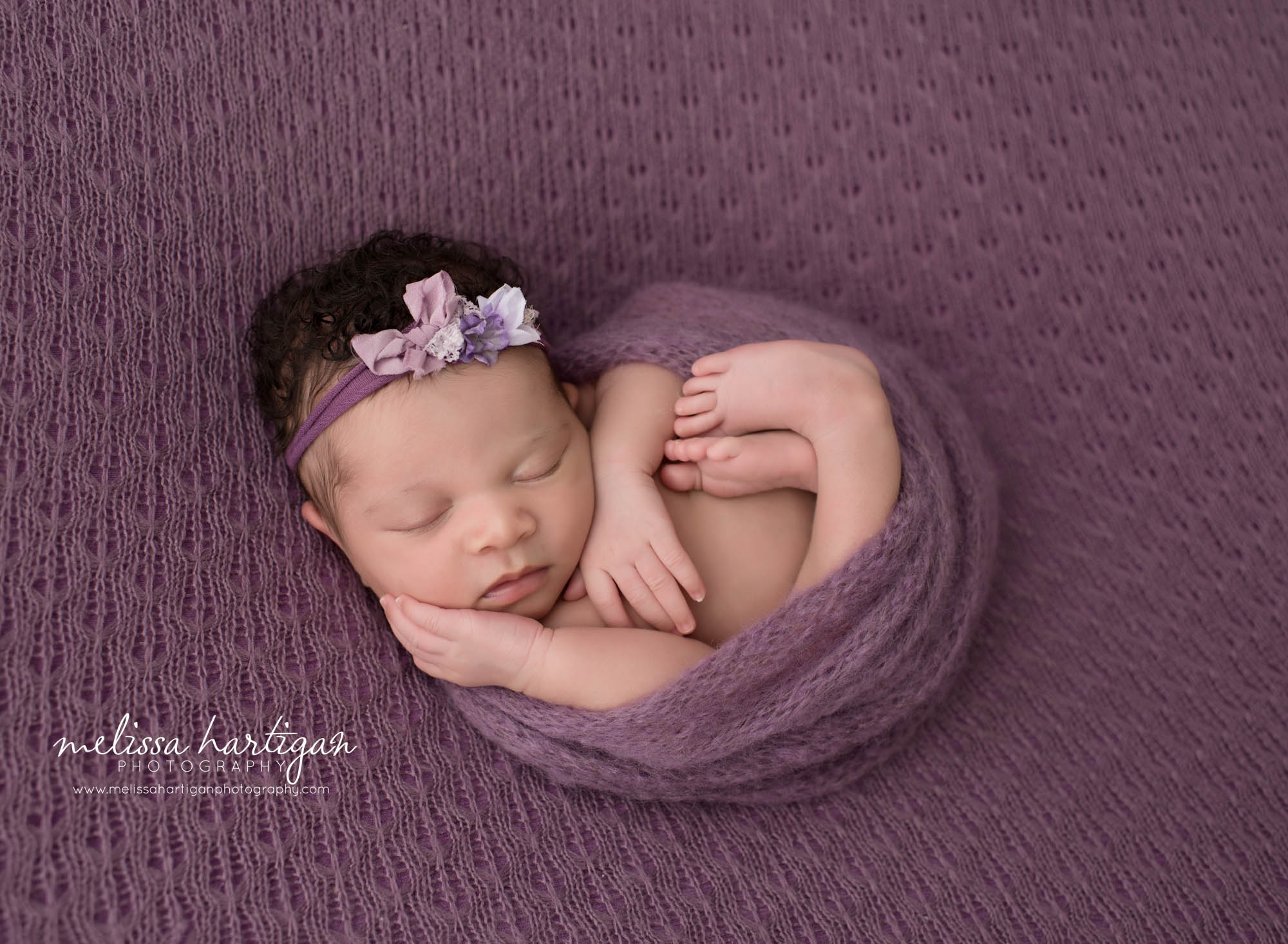baby girl curled on textured purple blanket wrapped knitted purple egg wrap CT baby & family photographer Middletown Conventry Haddem Connecticut