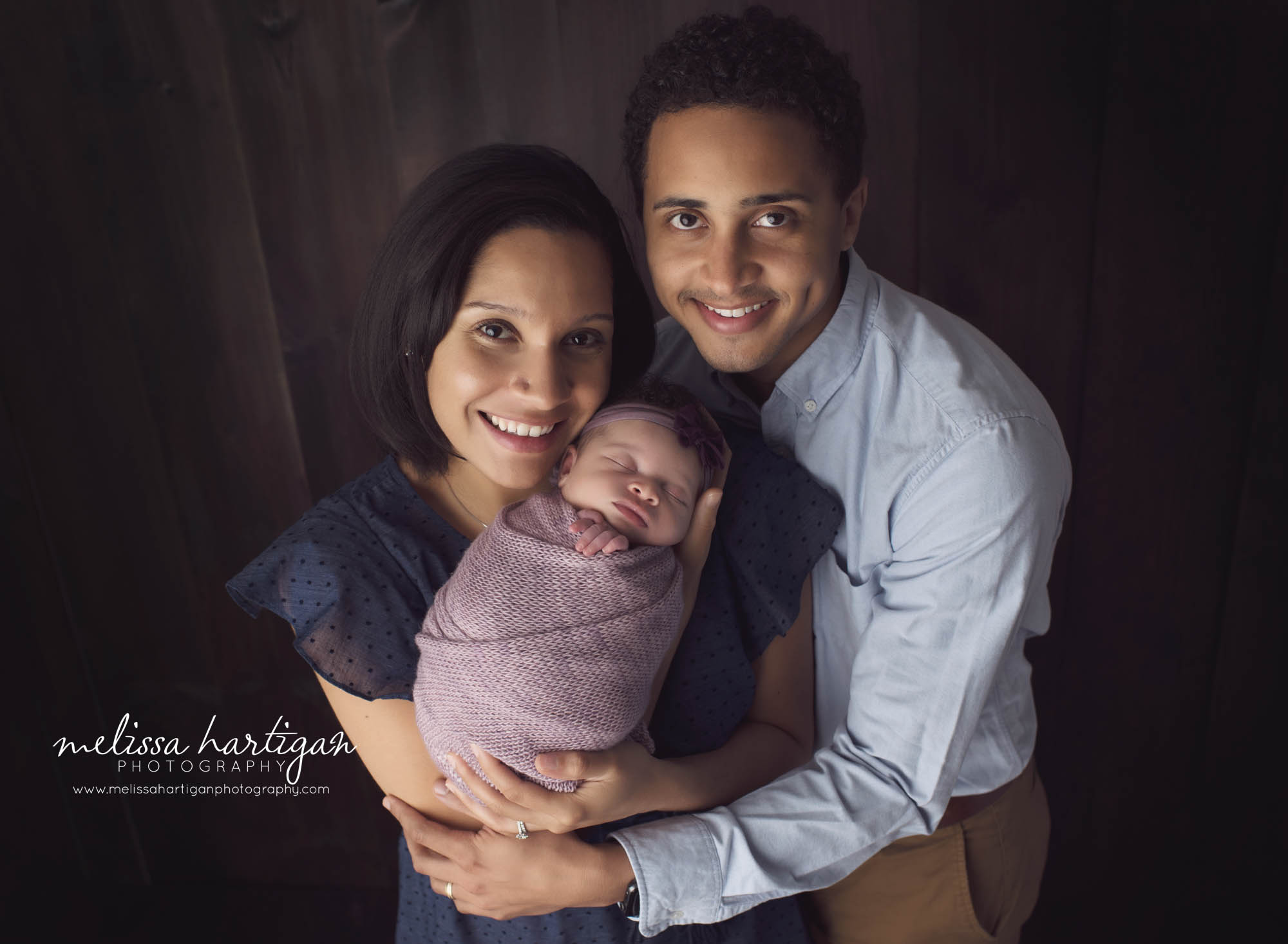 family of three pose with mom dad and baby newborn family photo session CT newborn baby photographer