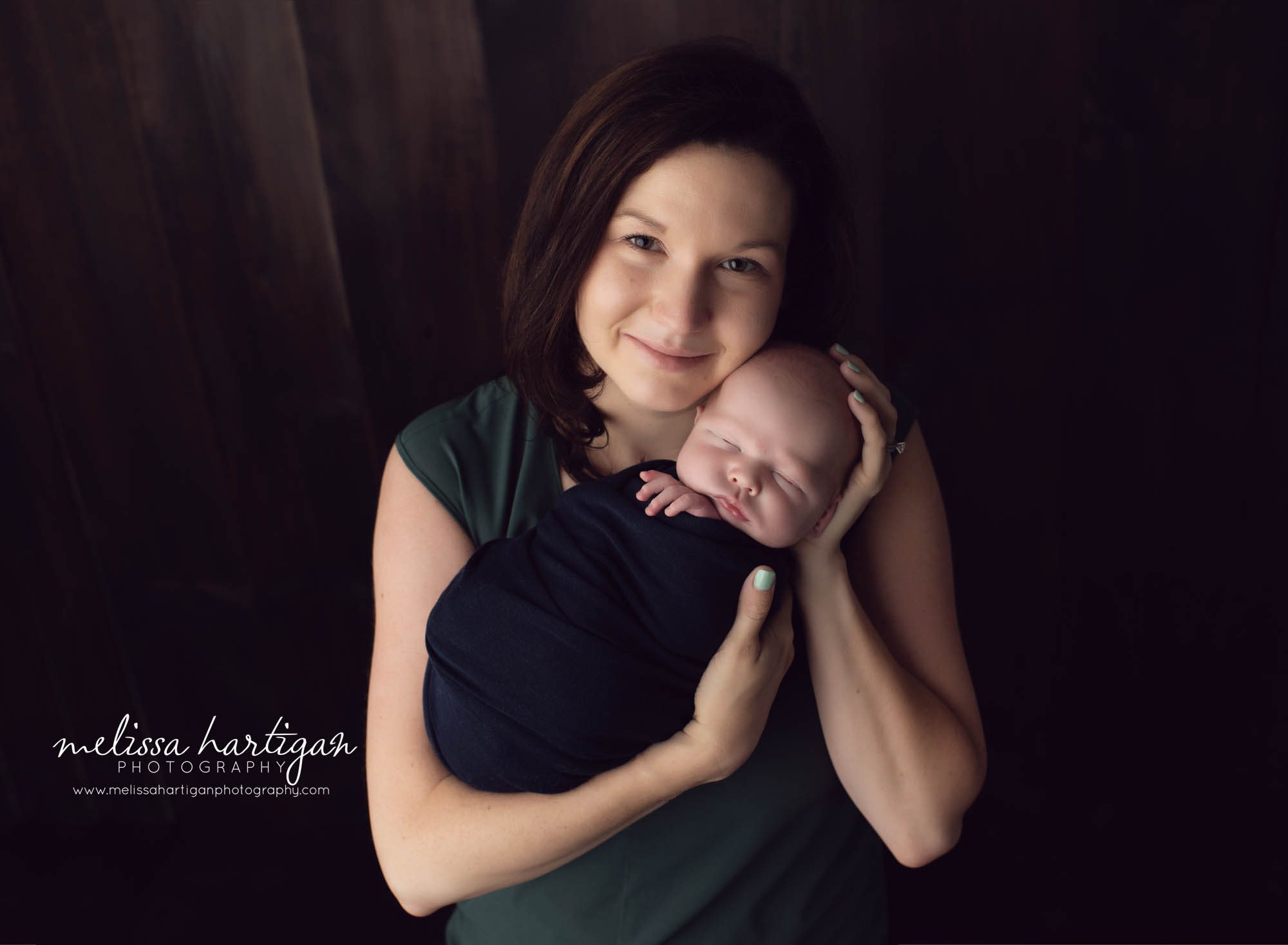 Mom posed with baby boy wrapped studio photos