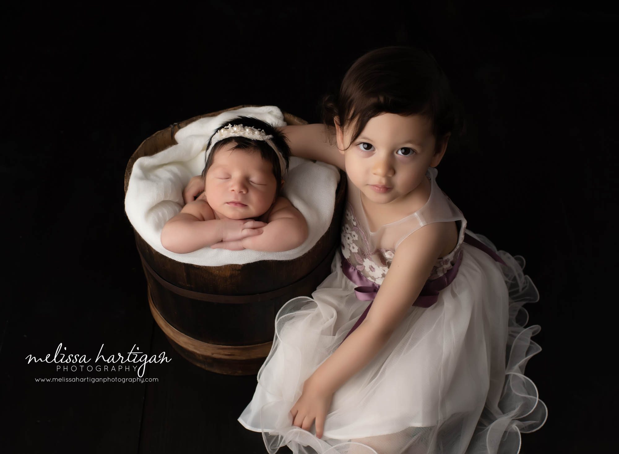 newborn baby girl posed in bucket with sister sitting beside her newborn and sibling photography CT newborn photographer