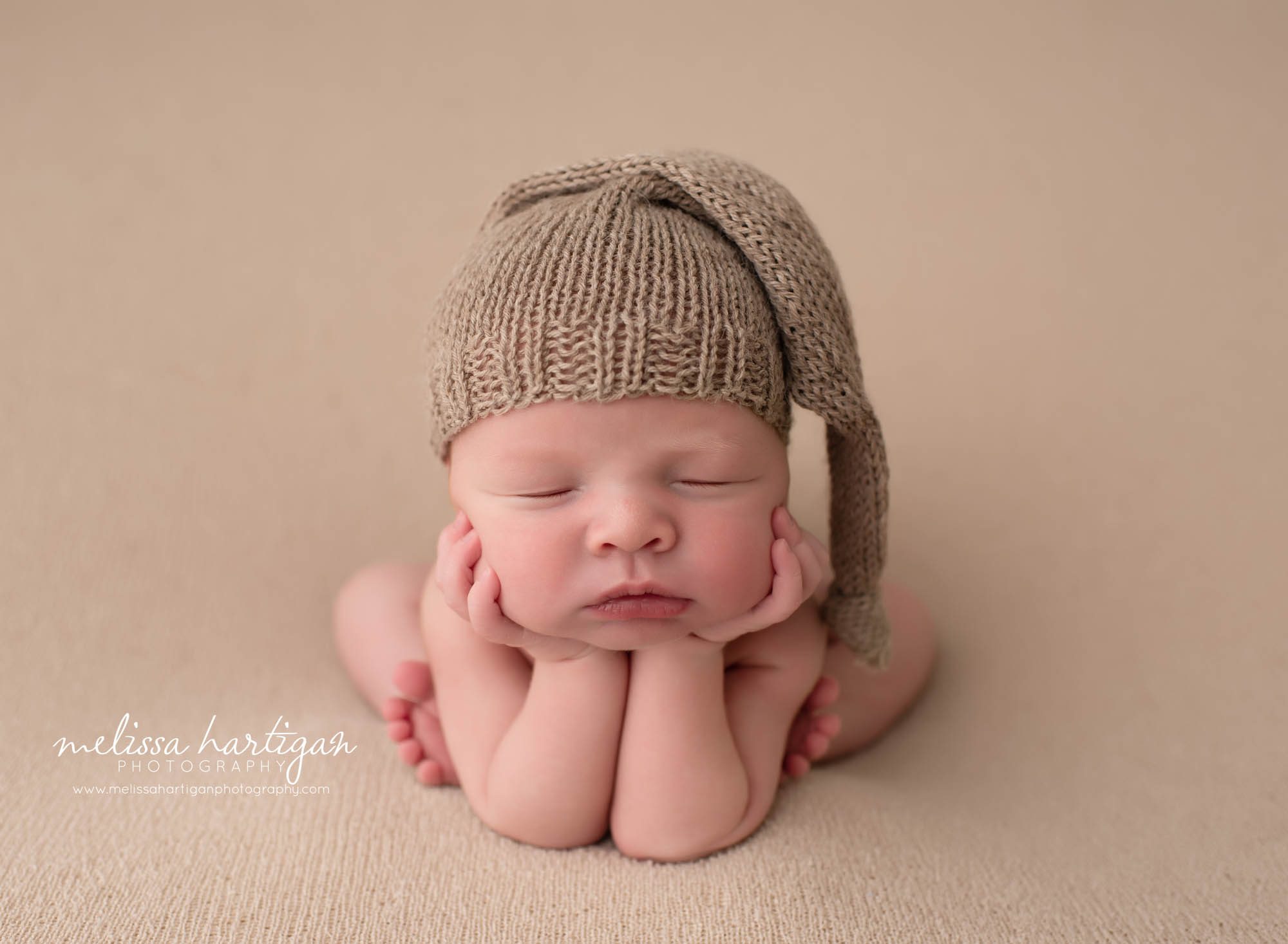 baby boy posed froggy pose with knitted sleepy cap newborn photography CT newborn photographer
