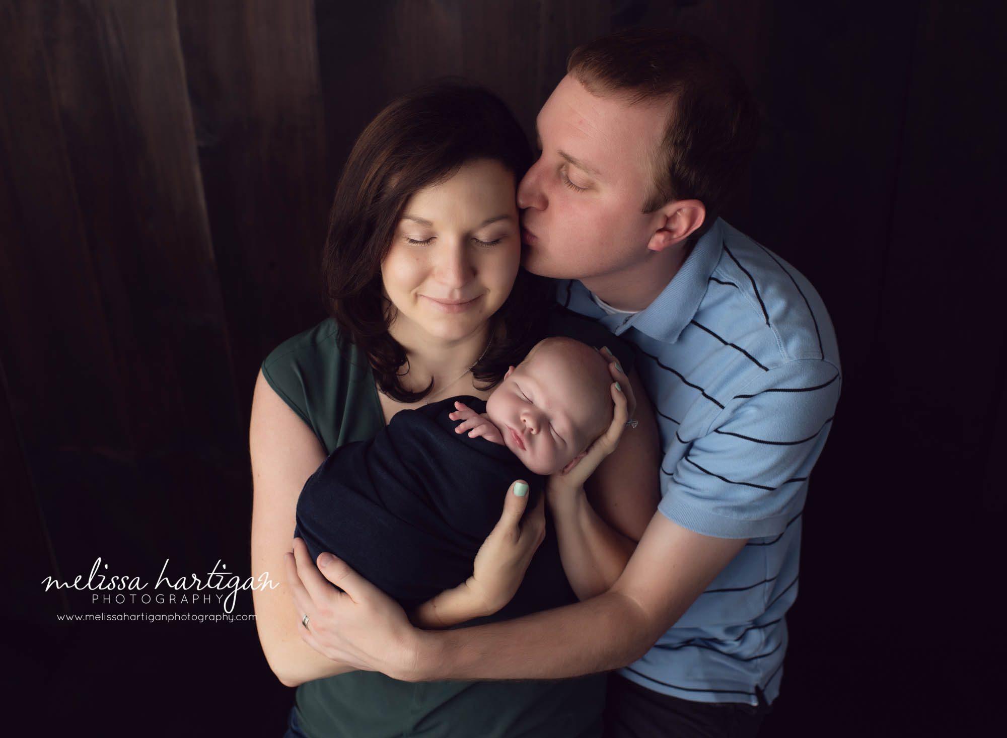 Newborn photos CT family poses with mom dad baby wrapped up