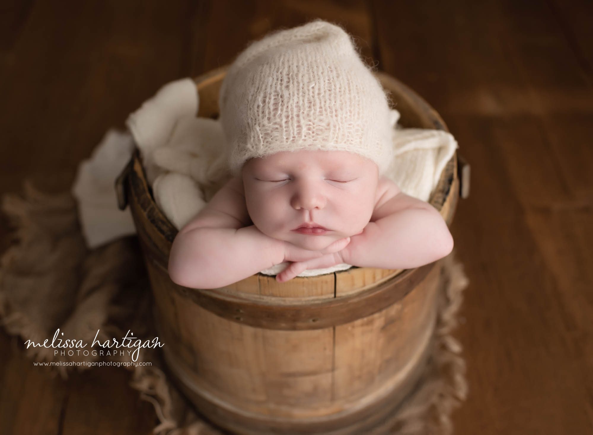 Baby posed in a wooden barrel with head on hands studio baby photography photos CT
