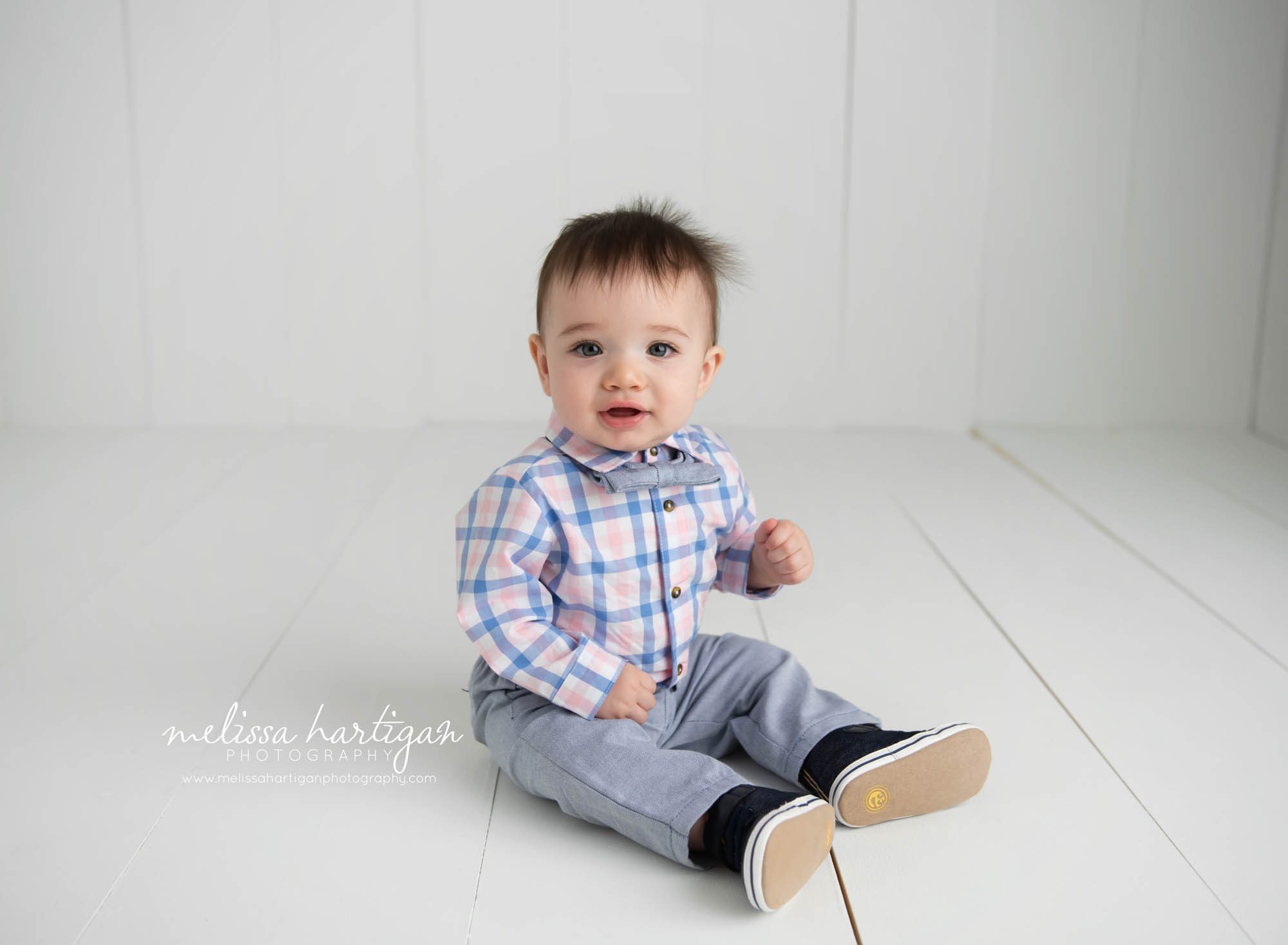 Baby boy sitting on white wooden boards baby milestone photography CT
