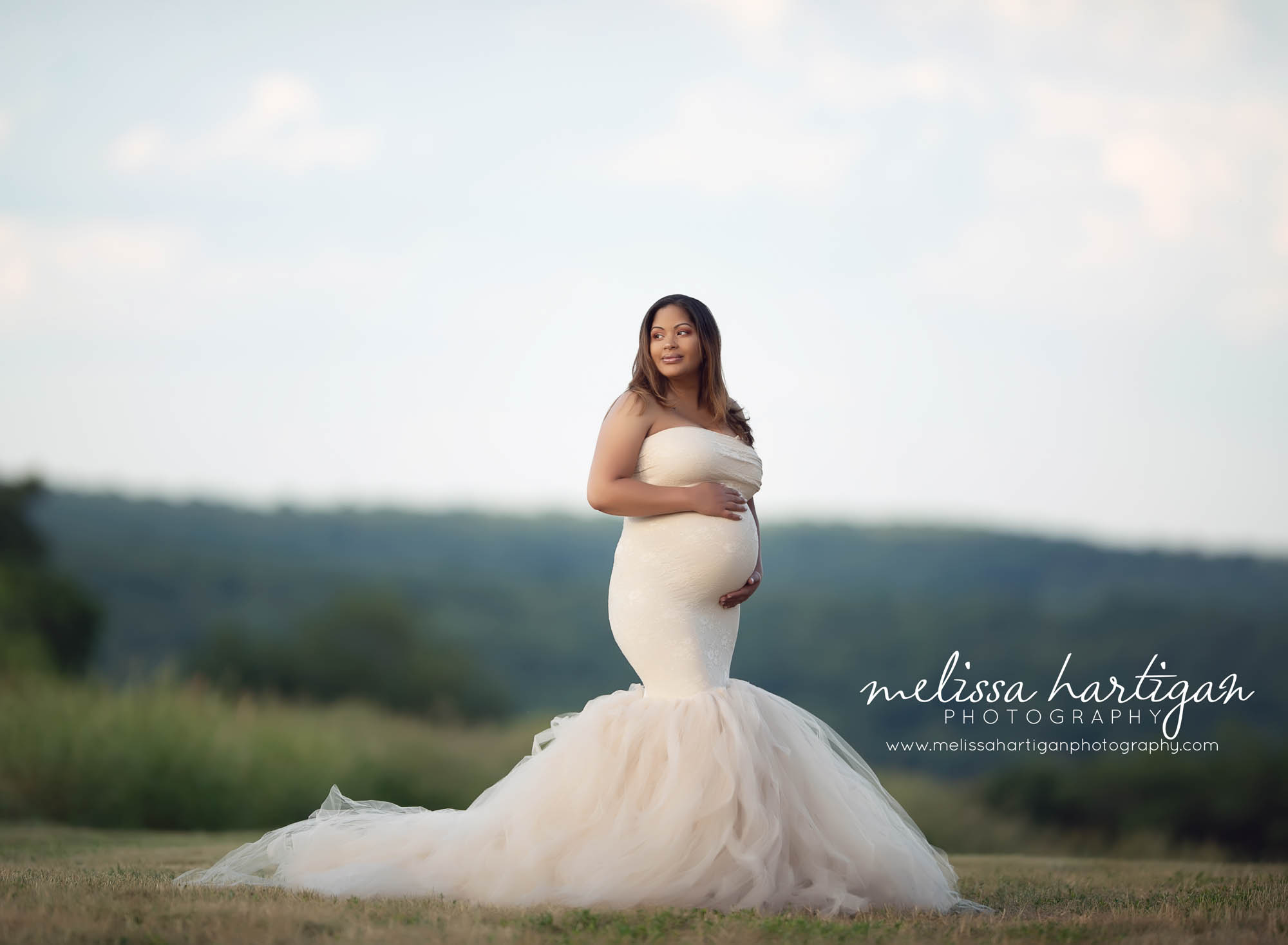 beautiful expectant mom wearing mermaid style cream couture style strapless fitted maternity dress with tulle bottom with train CT maternity photography Maternity newborn photographer Connecticut