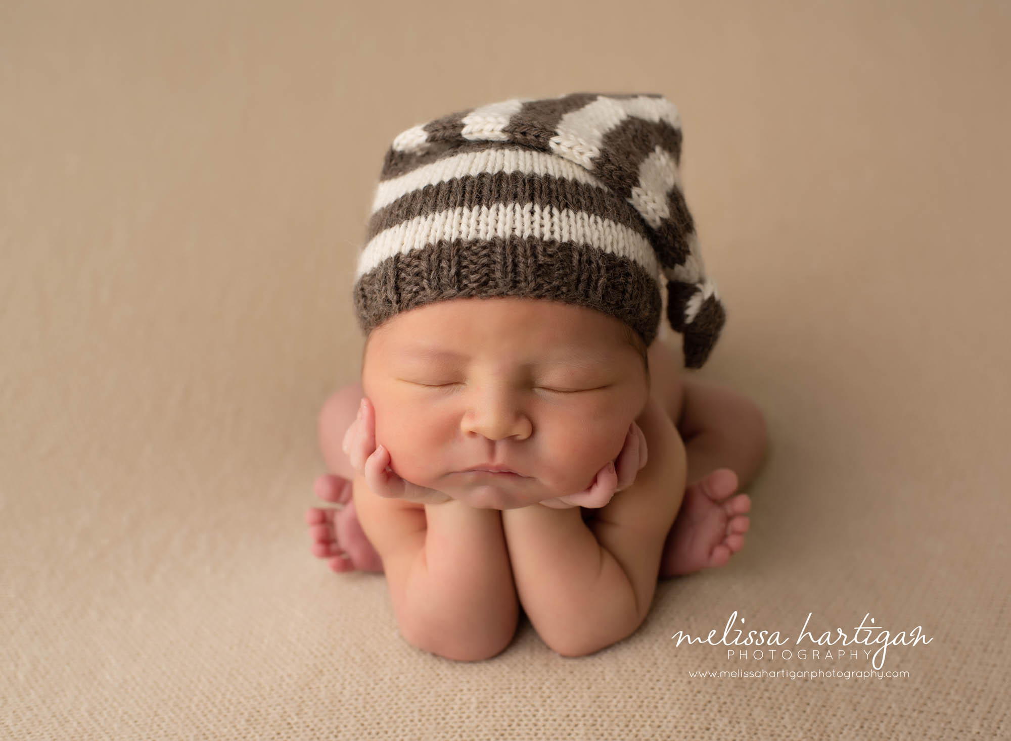 Baby boy posed in groggy pose newborn photography