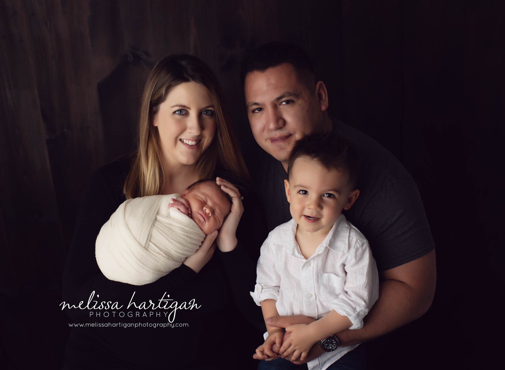 Family photo with newborn baby boy, older toddler brother and mom and dad studio newborn photography CT