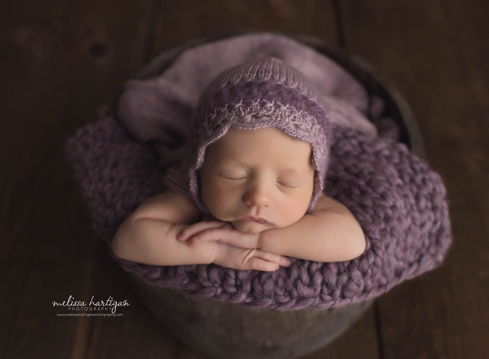 Baby girl wearing purple knitted bonnet posed in bucket Baby photography CT