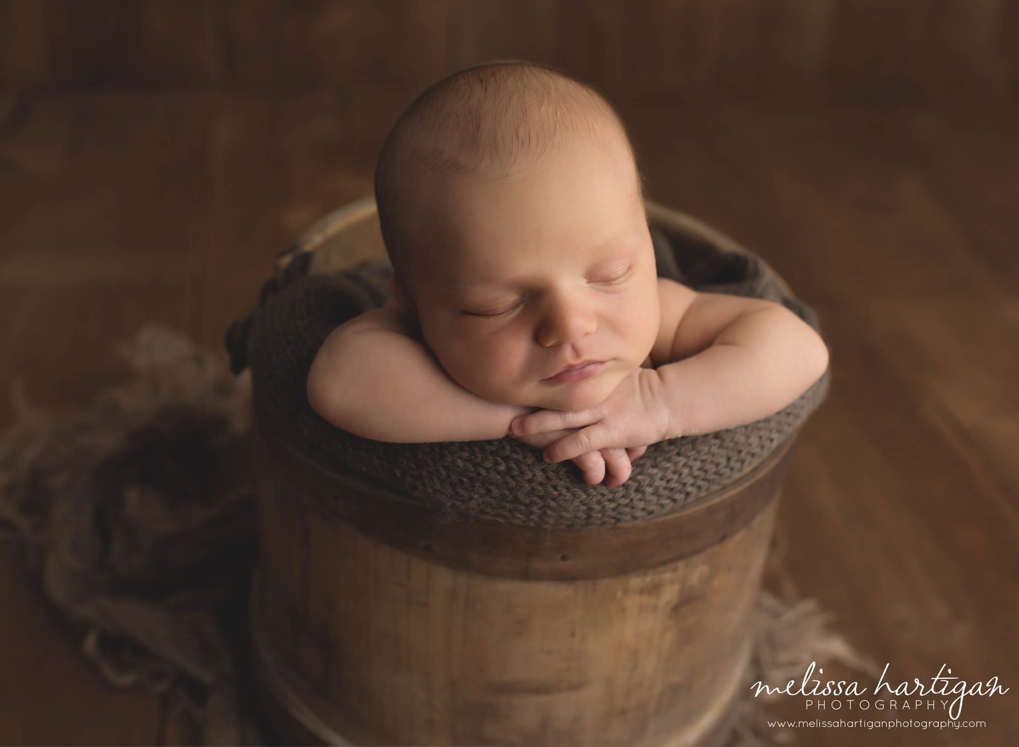 baby boy posed in rustic style bucket