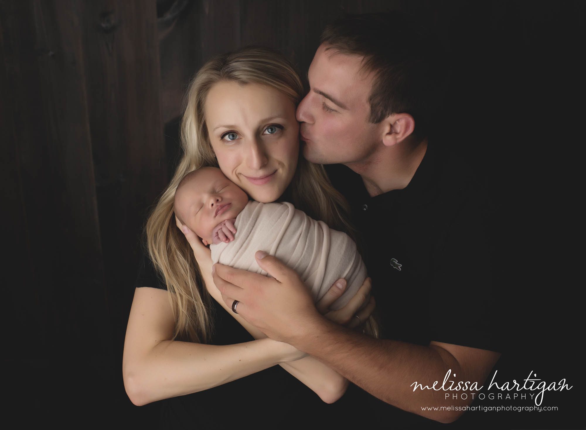 newborn baby wrapped in parents arms studio family photo newborn photos CT session