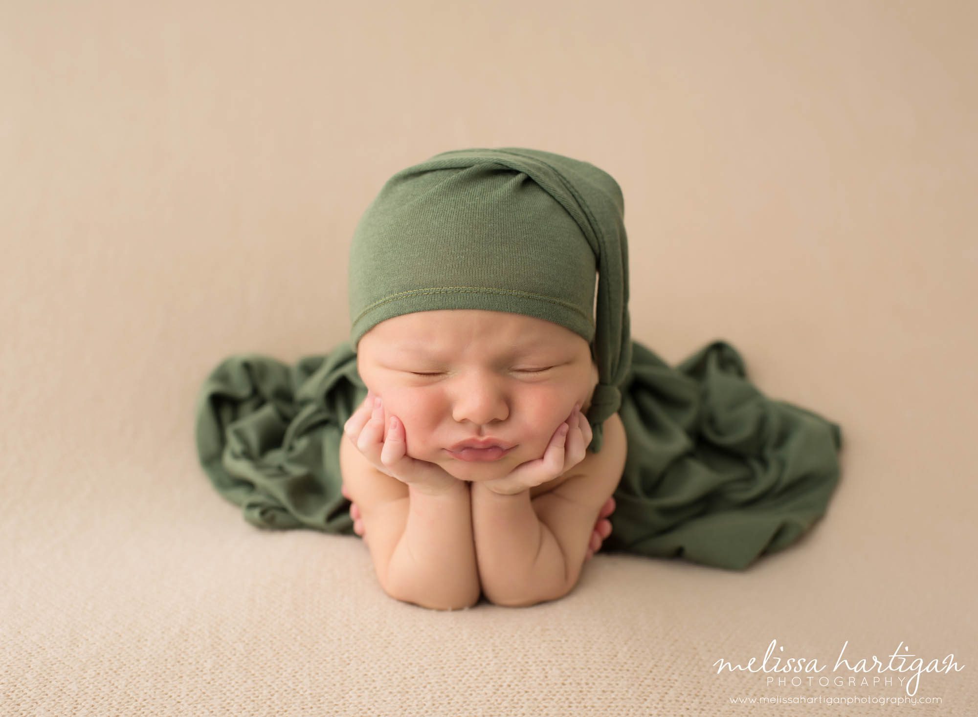 Baby boy posed in froggy pose with green and tan colors newborn photographer CT