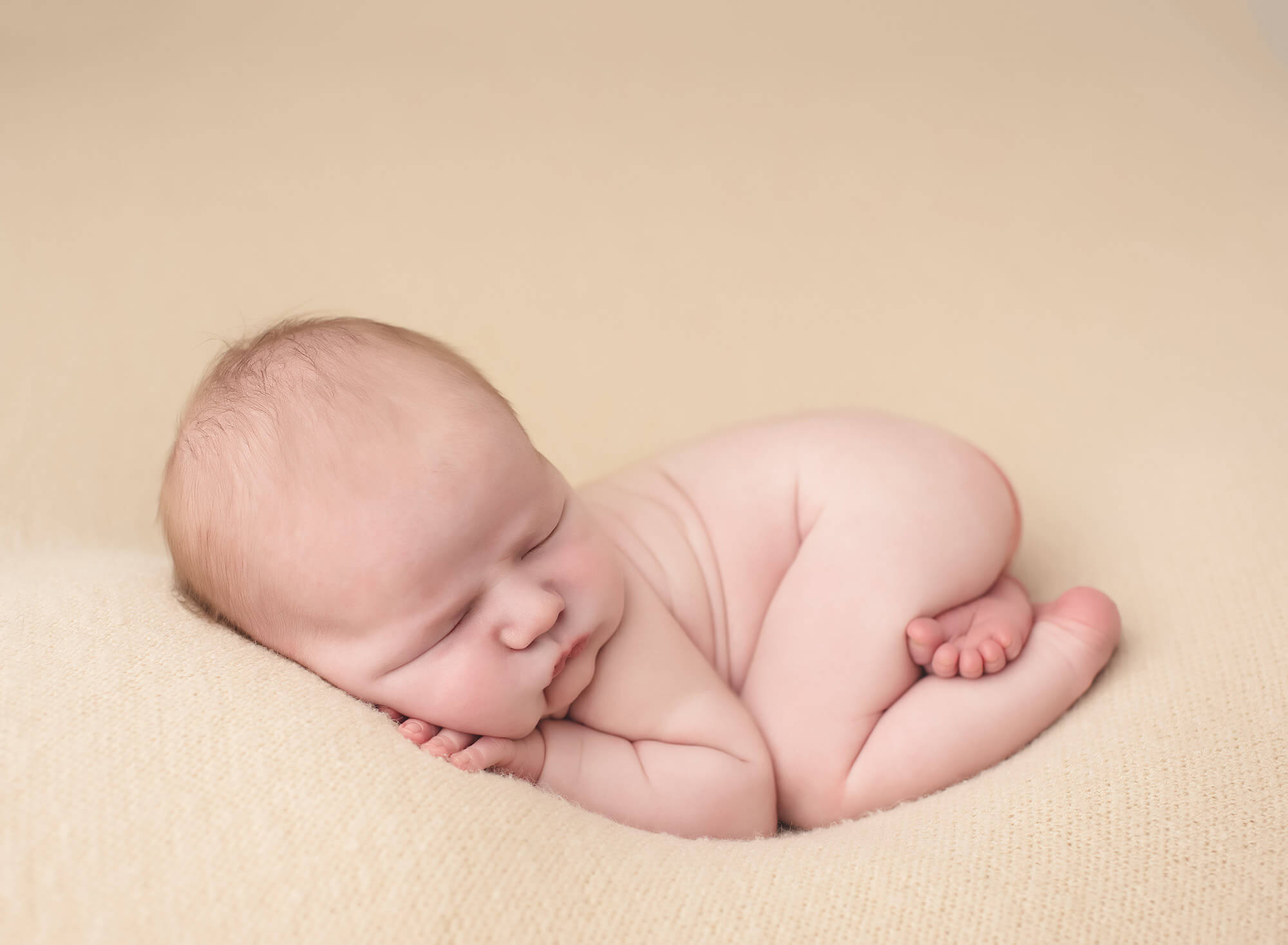 Newborn on tan blanket by Melissa Hartigan Photography in Coventry CT