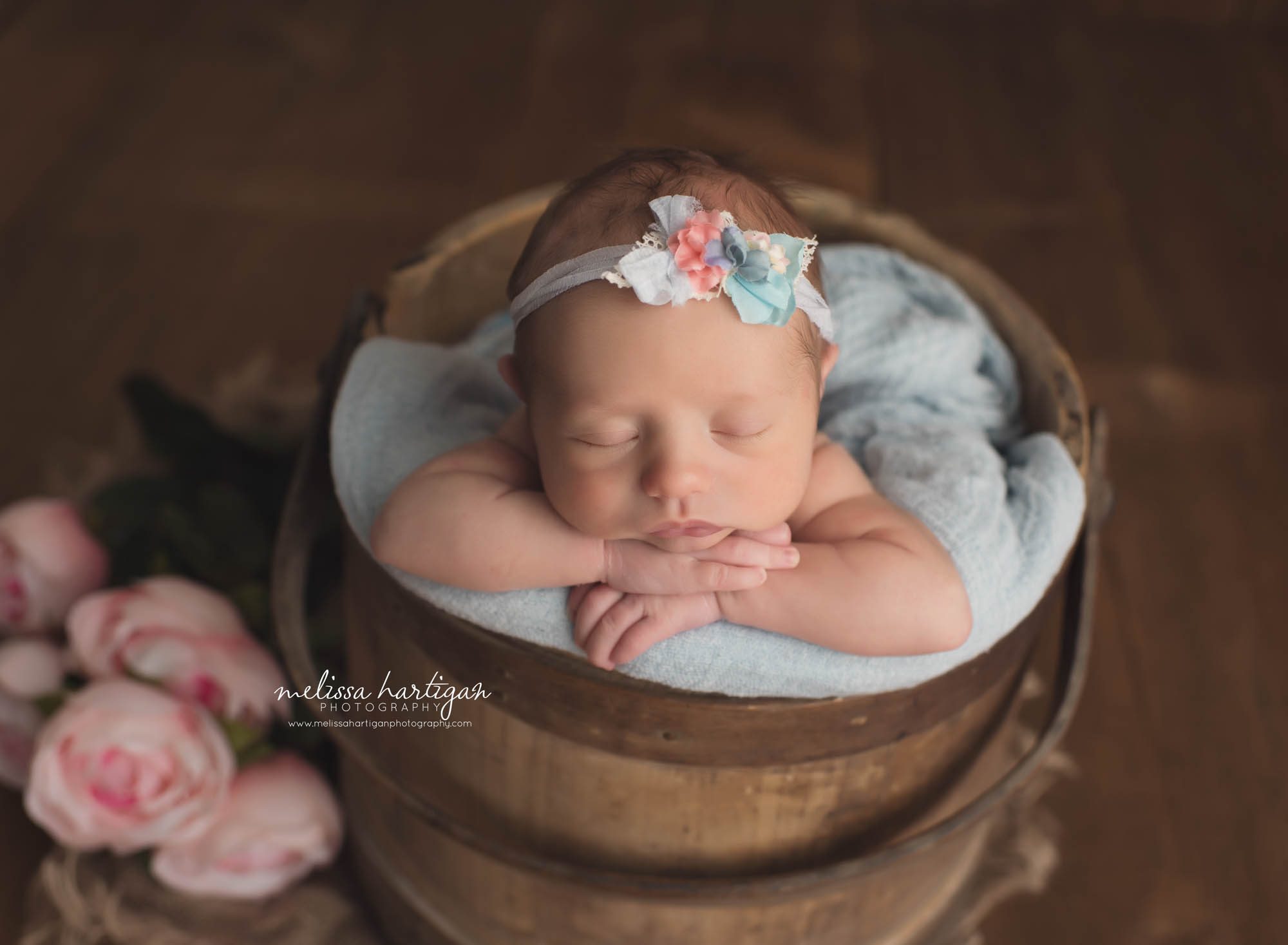 newborn baby girl posed in rustic bucket with peony flowers and light blue floral headband Newborn Photography CT