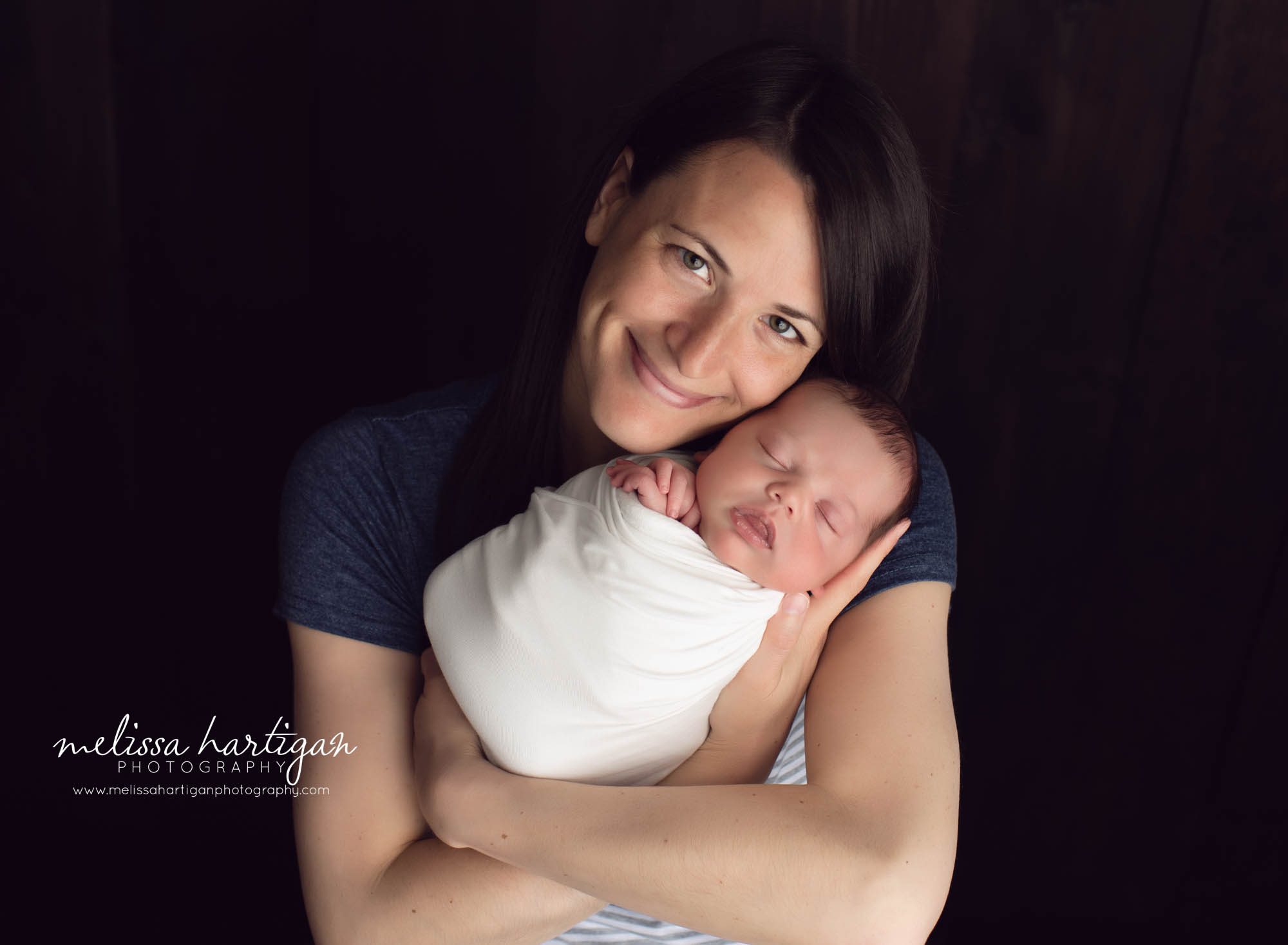 mom and baby boy newborn photo pose baby wrapped in white wrap