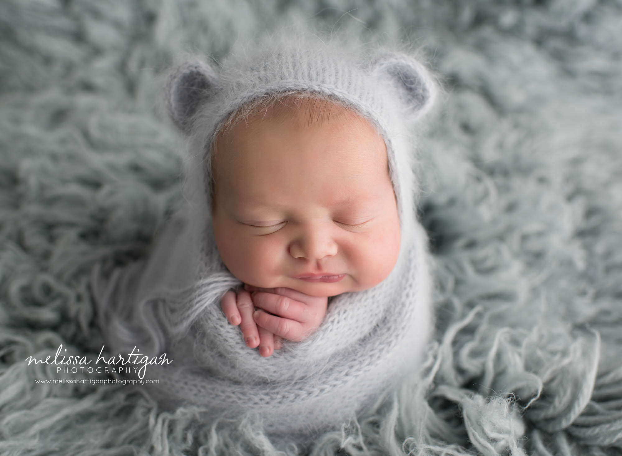 baby boy wrapped in grey angora wrap with matching angora knitted bear bonnet CT newborn photographers