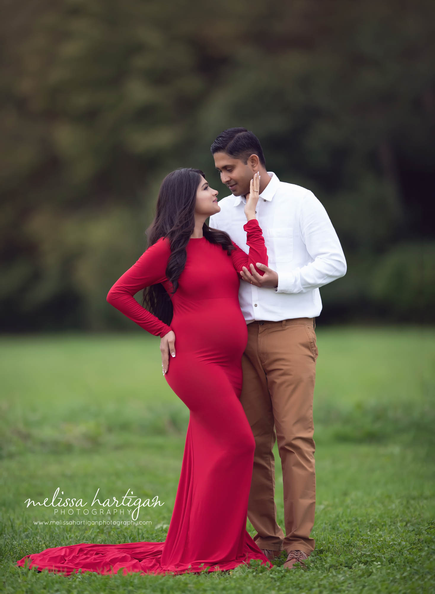 Expectant couple standing maternity pose mom wearing fitted maternity dress Stamford CT Maternity Photographer
