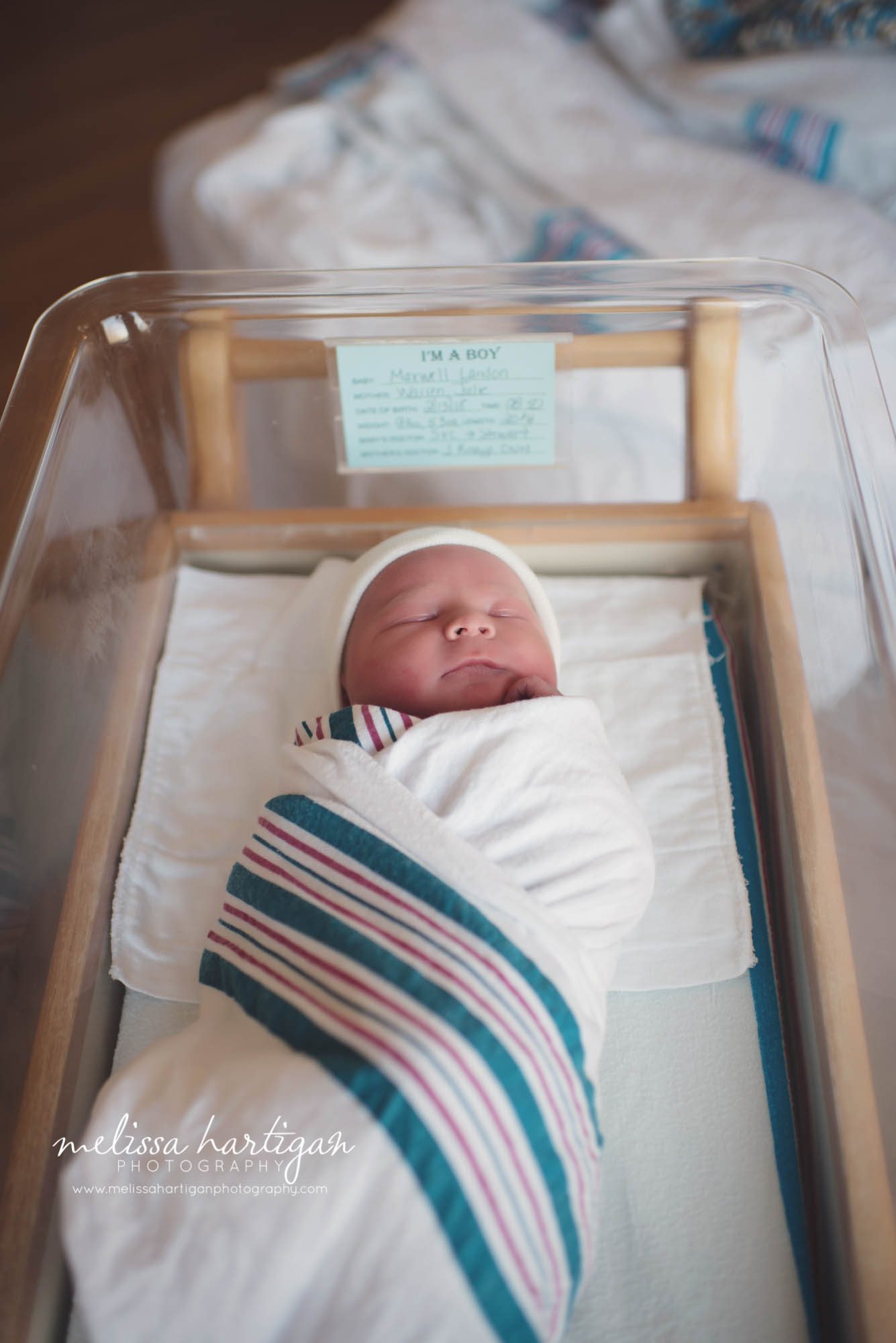 newborn baby boy in hospital basinette