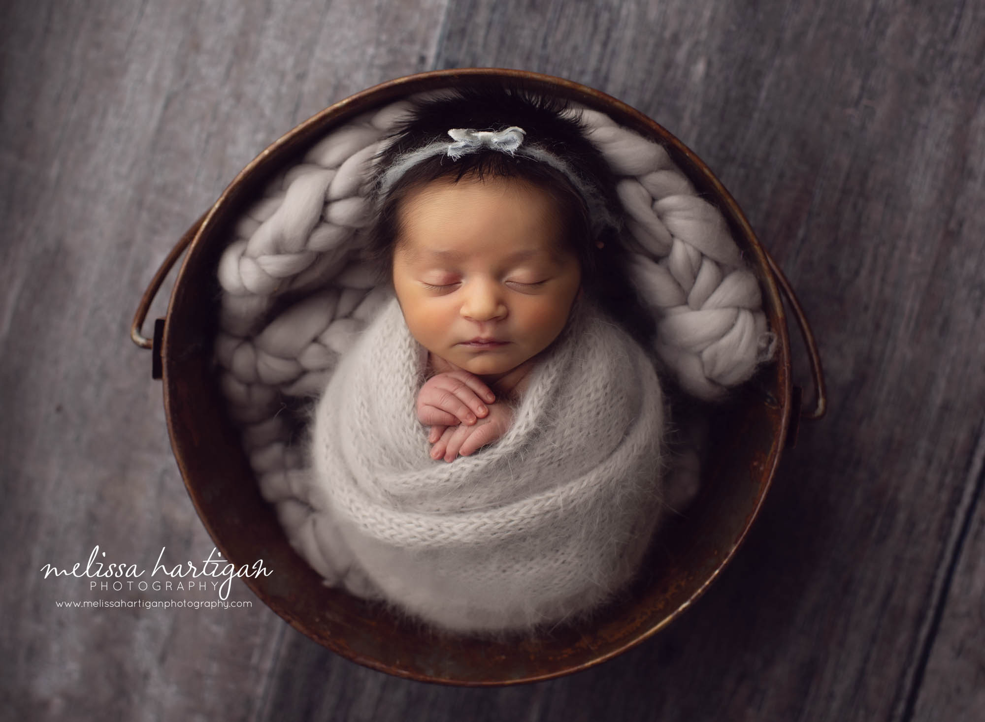Baby girl wrapped potato sack wrap in bucket with gray layer