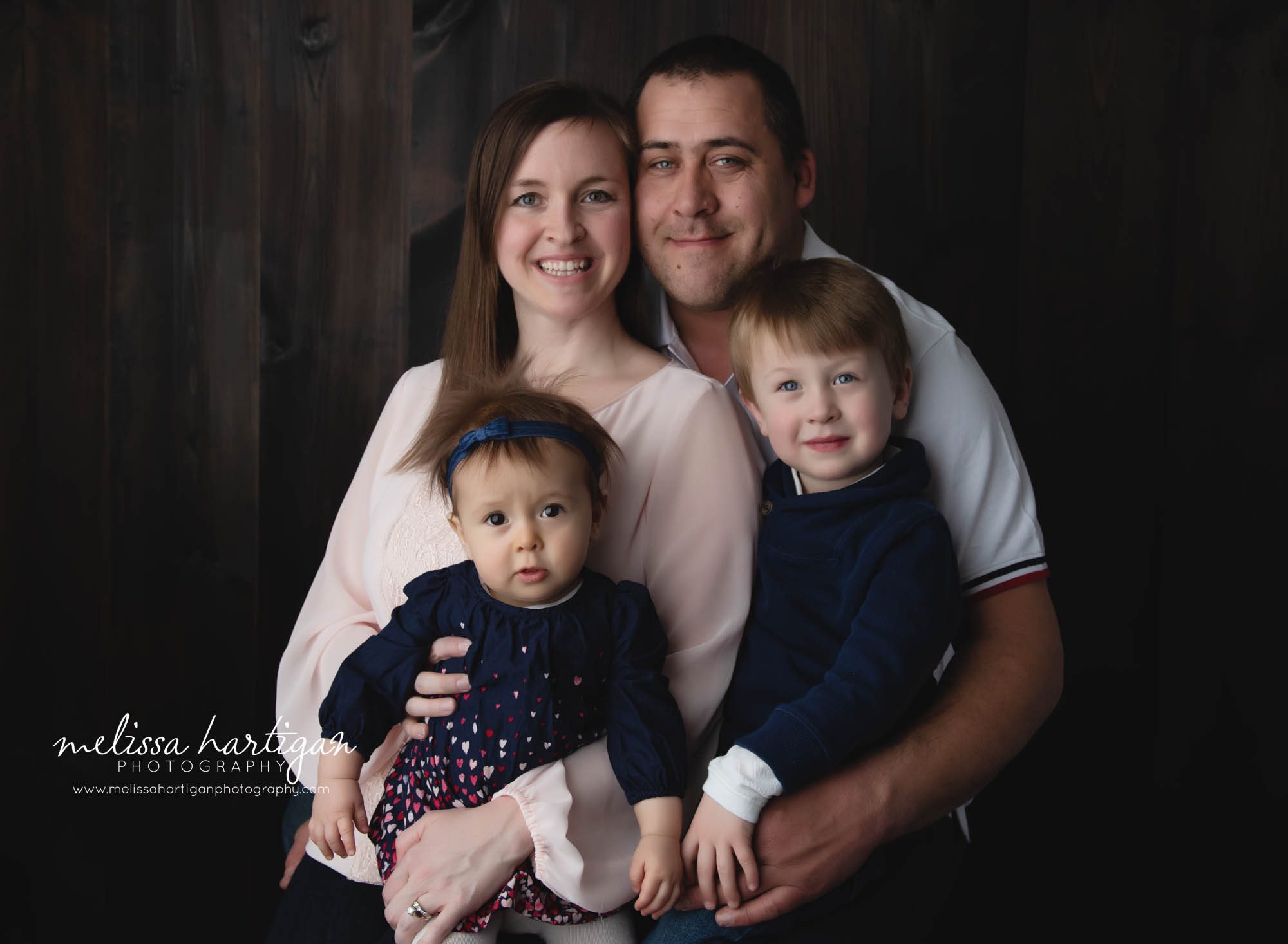 family photo with mom dad toddler brother and baby girl sitting up milestone session Coventry CT family photographer