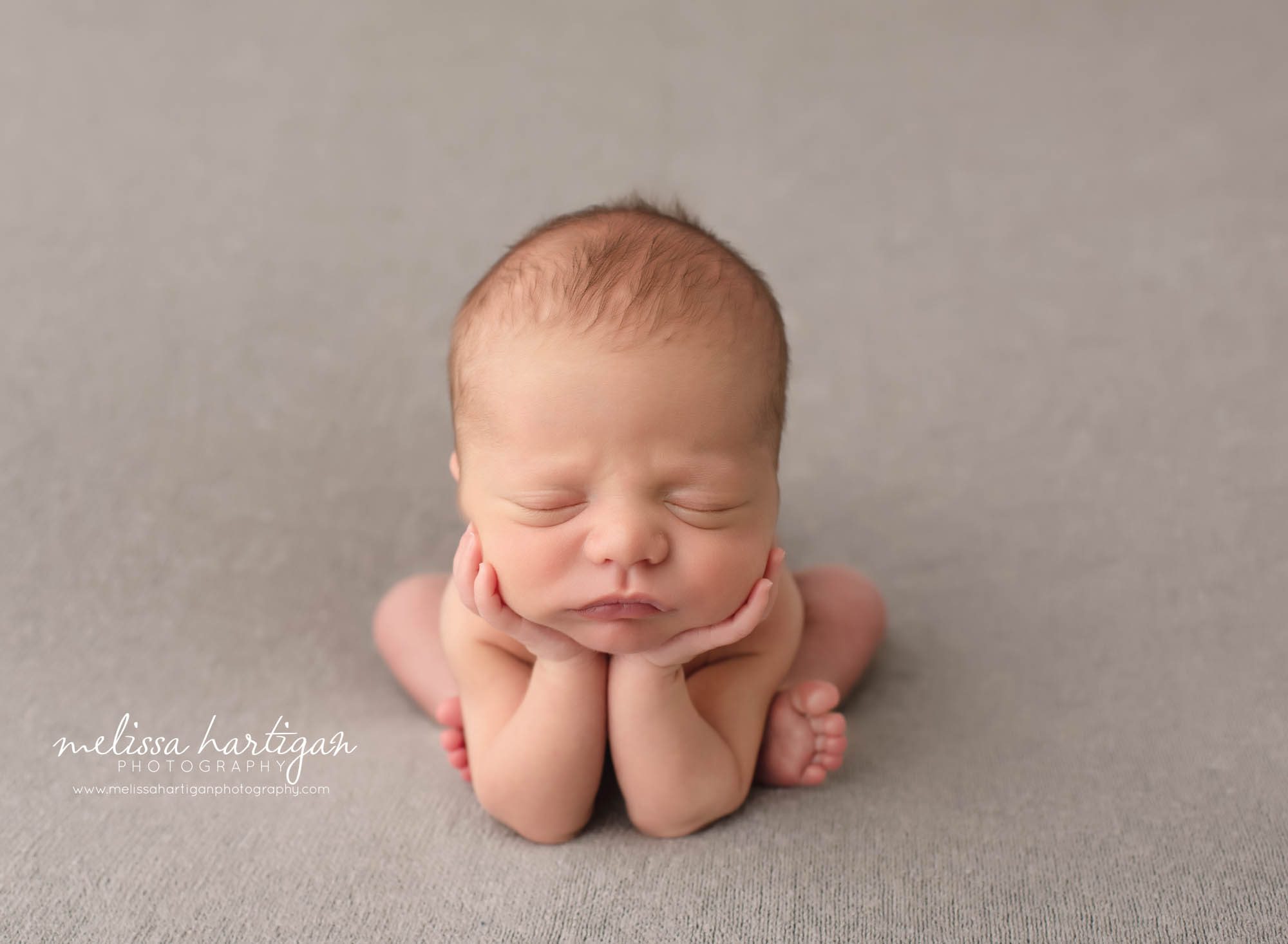 Baby boy groggy pose with hands under chin CT newborn photography