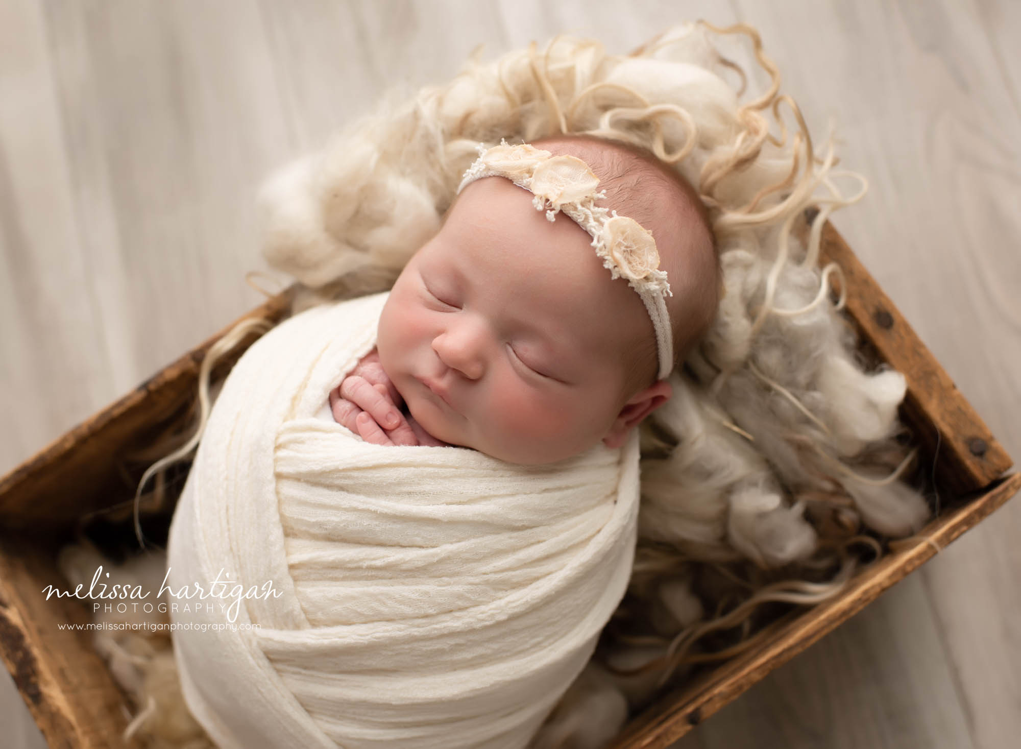 Babygirl wrapped and posed in a rustic crate CT newborn Photography