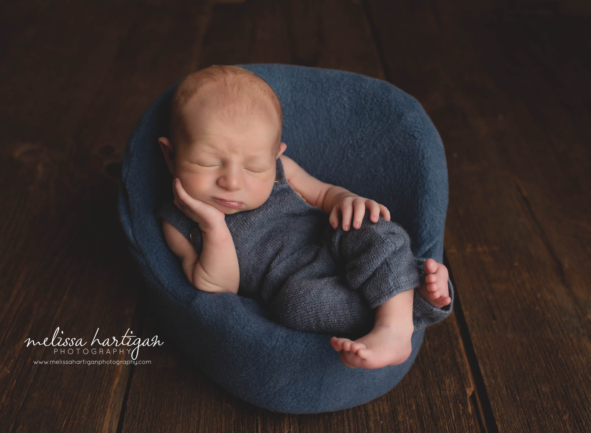 baby boy posed in posing chair wearing blue outfit