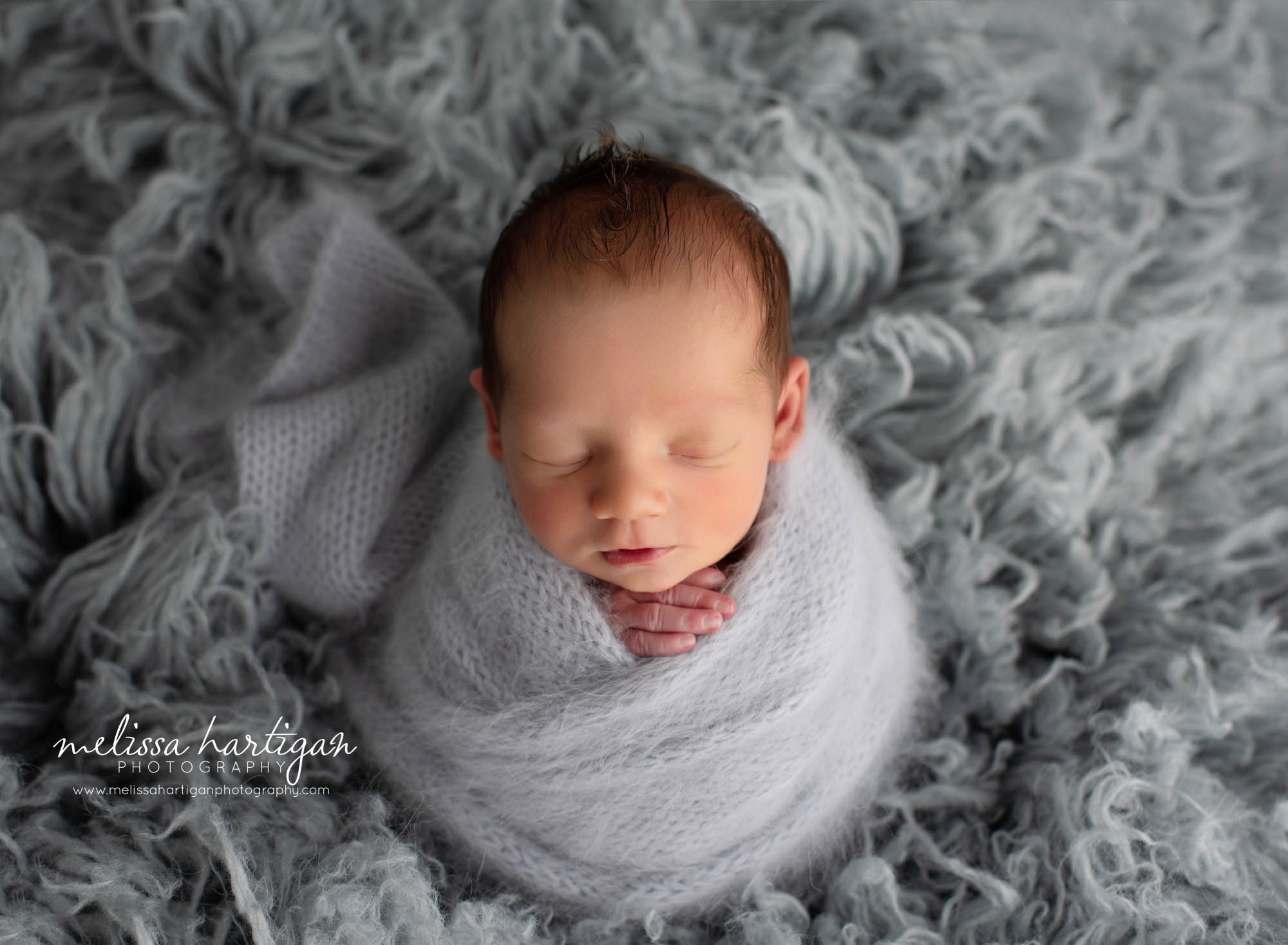 Baby boy wrapped in knitted light grey wrap Connecticut Newborn photography