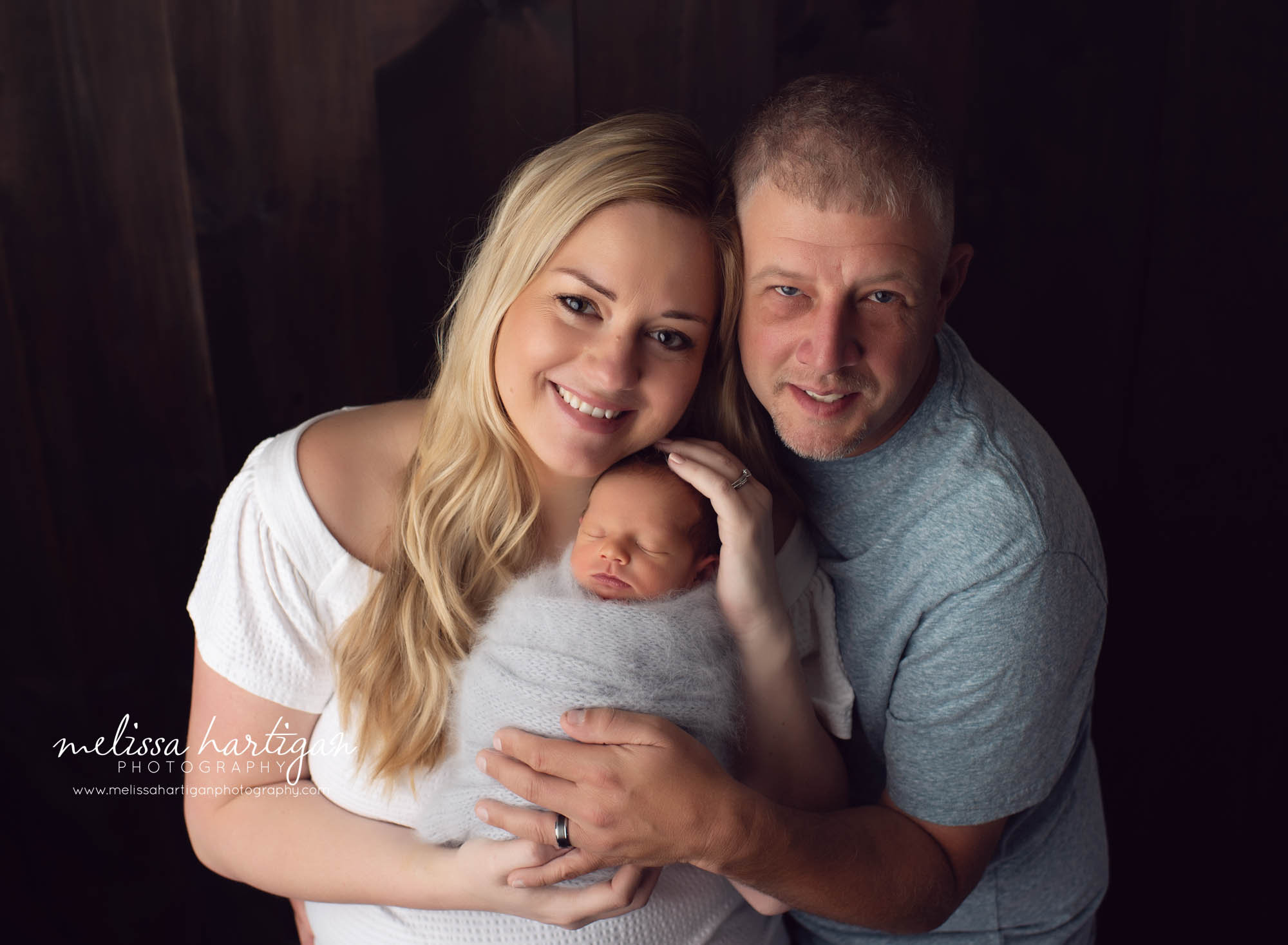 Mom dad and newborn baby boy studio family pose CT newborn photography