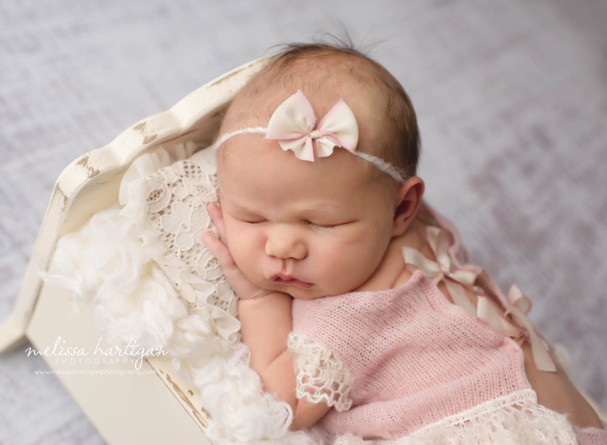 baby girl laying on tummy sleeping wearing knitted pink romper Newborn Photographer CT Glastonbury