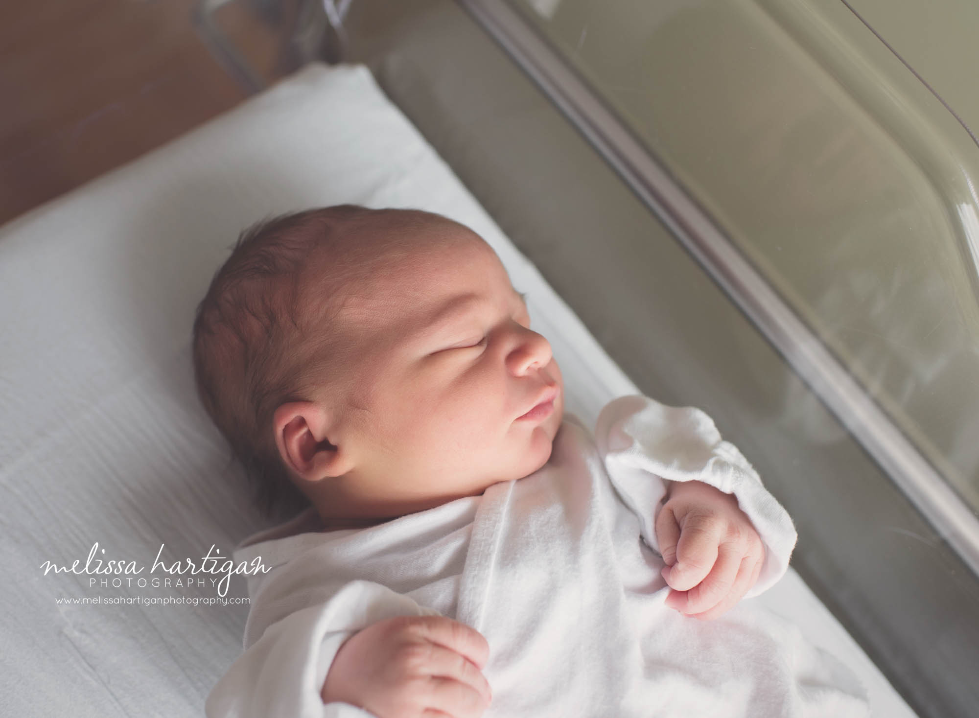 newborn baby boy laying in hospital bassinet newborn photographer CT