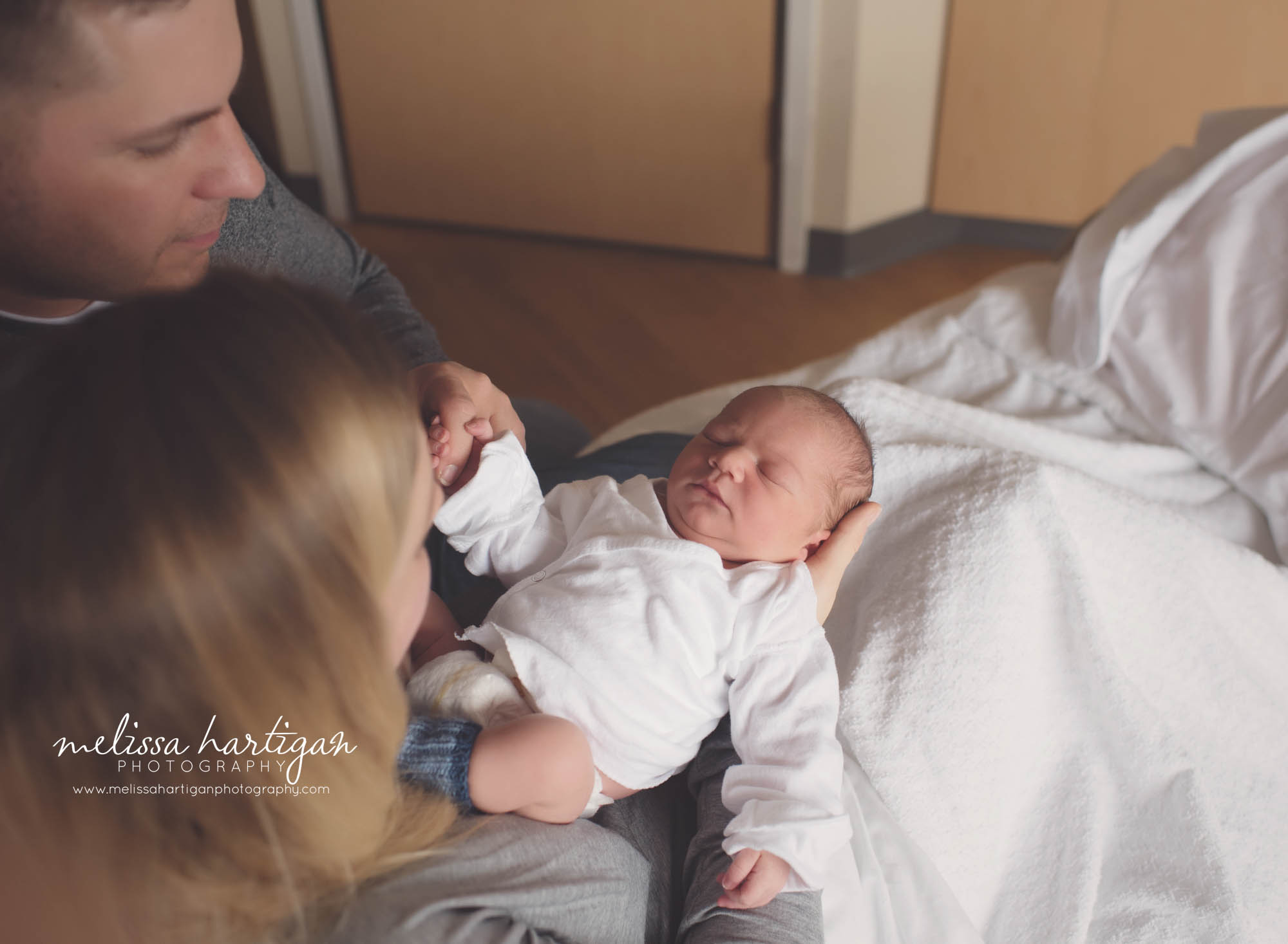 newborn baby boy held by his parents CT hospital photography session
