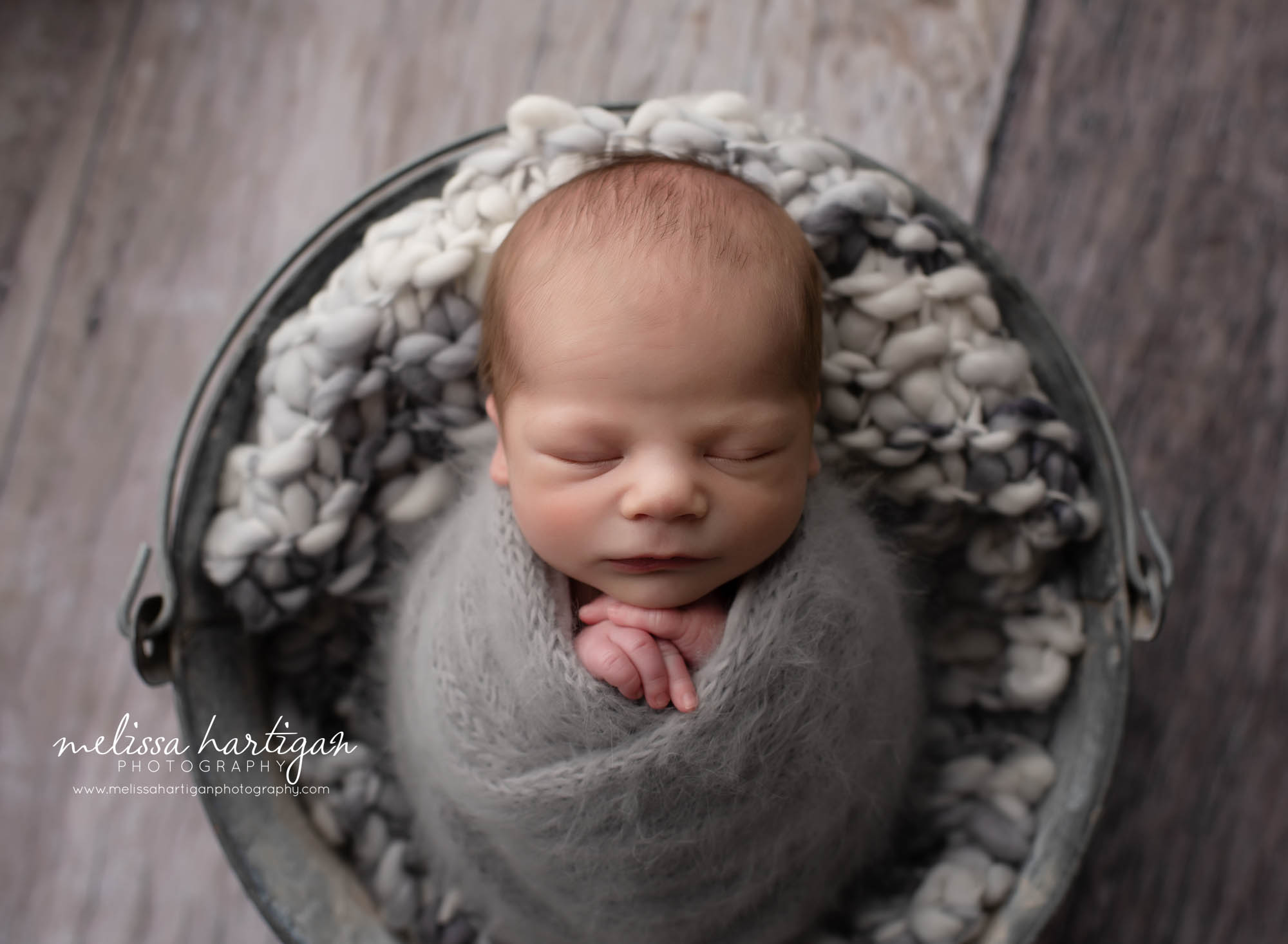 baby boy posed in metal bucket ct newborn photographer studio newborn photography session