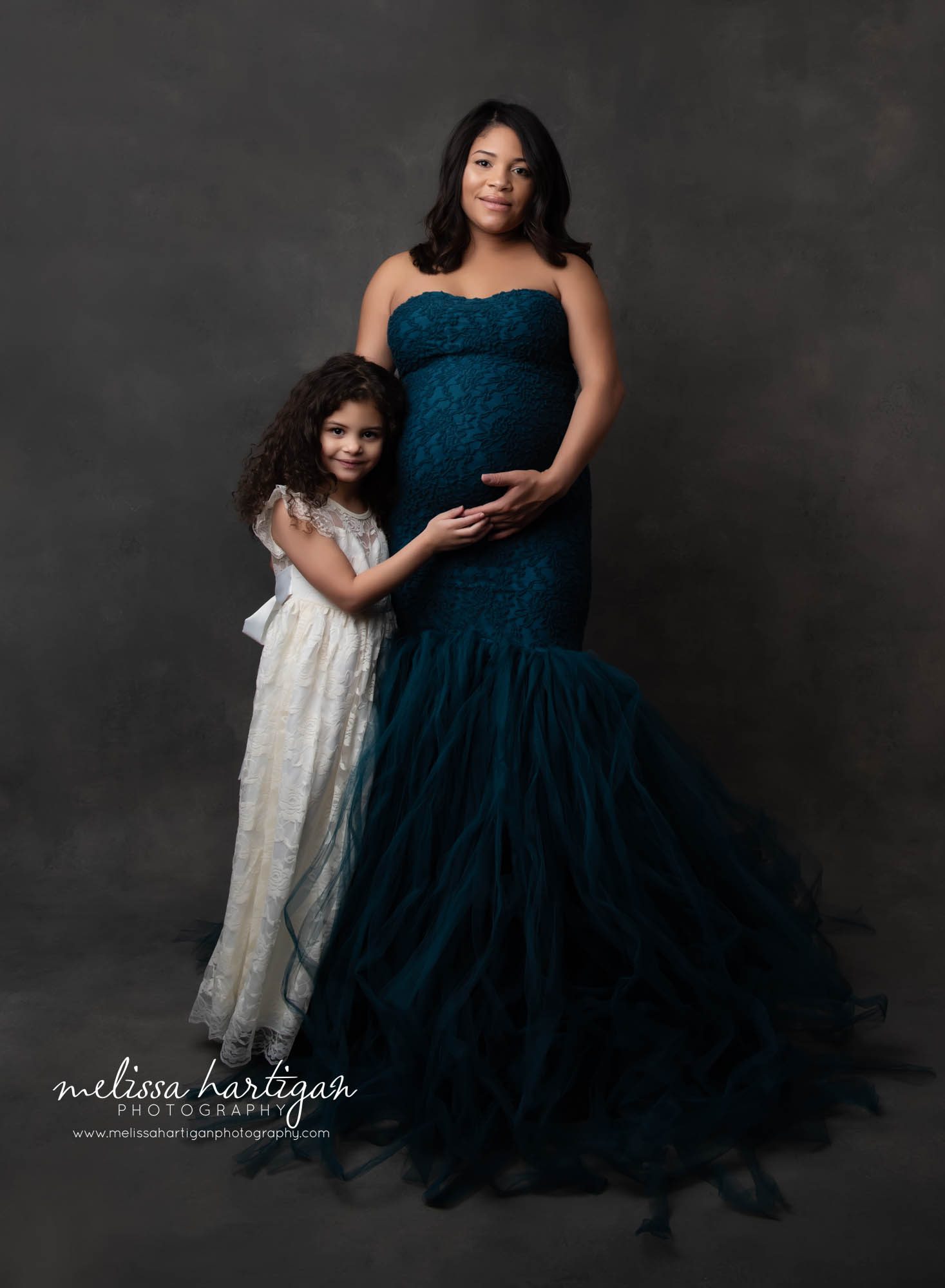 Studio maternity session expectant and daughter standing maternity pose