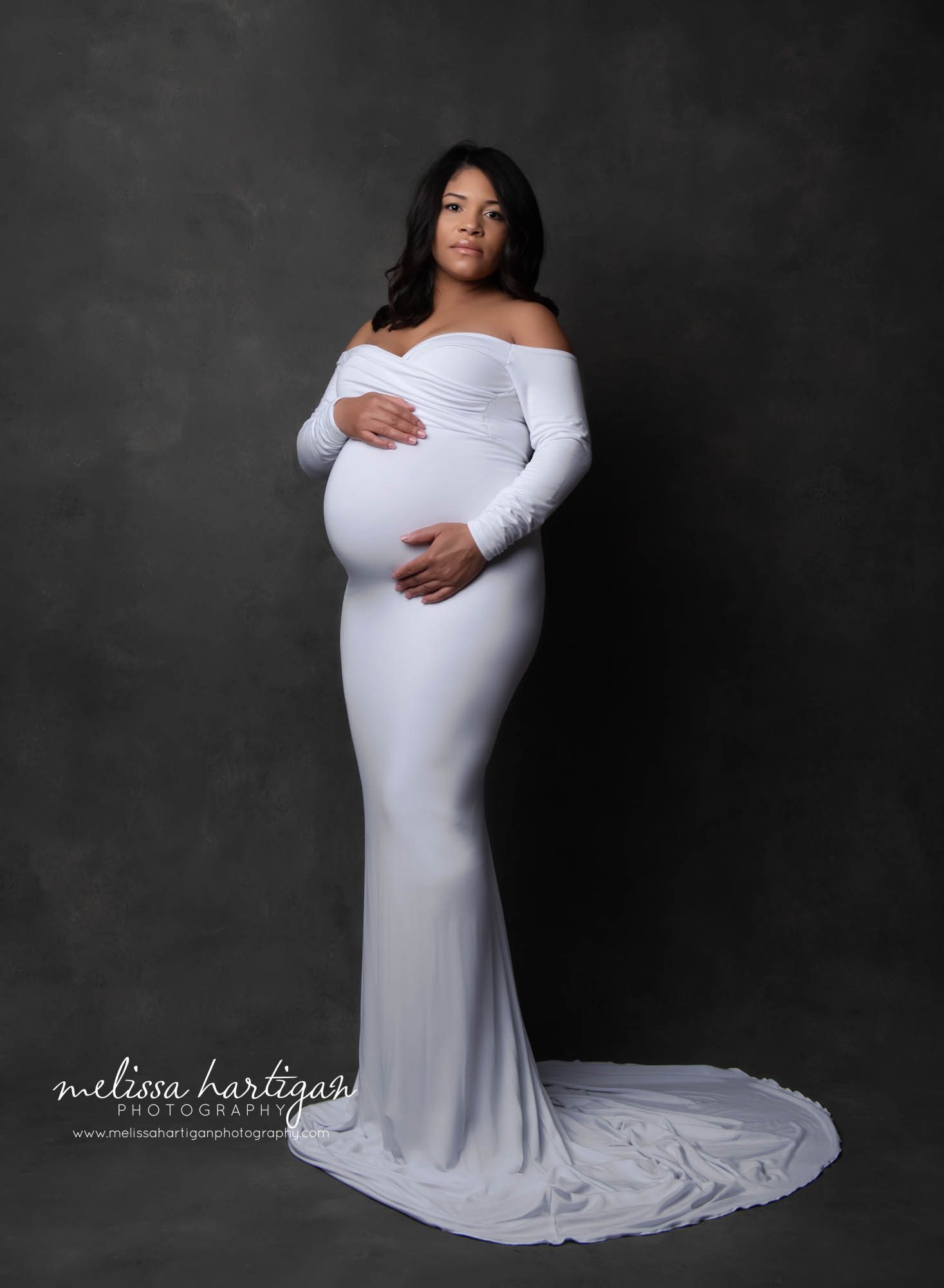 mom wearing sweetheart neckline long sleeved maternity dress in white CT maternity photography studio session