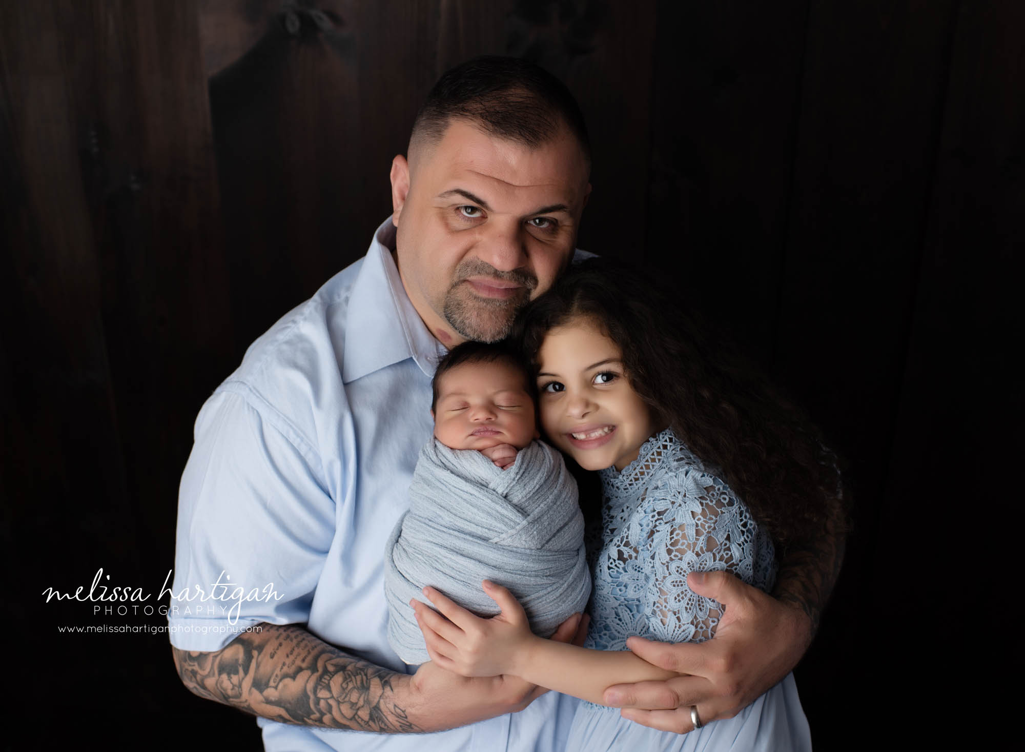 Newborn baby boy with dad and older sister studio photography session pose