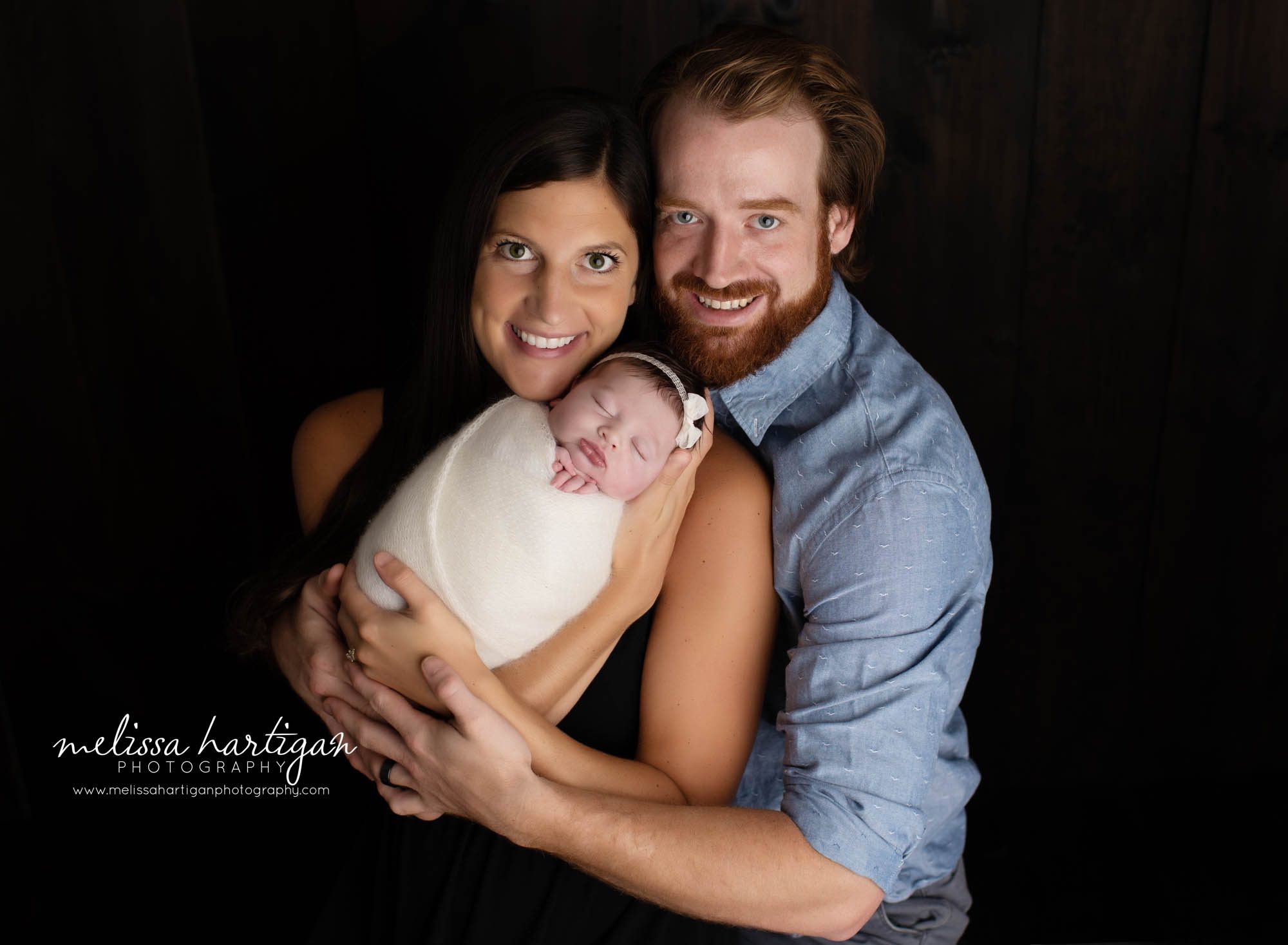 mom dad and baby girl newborn photography family pose